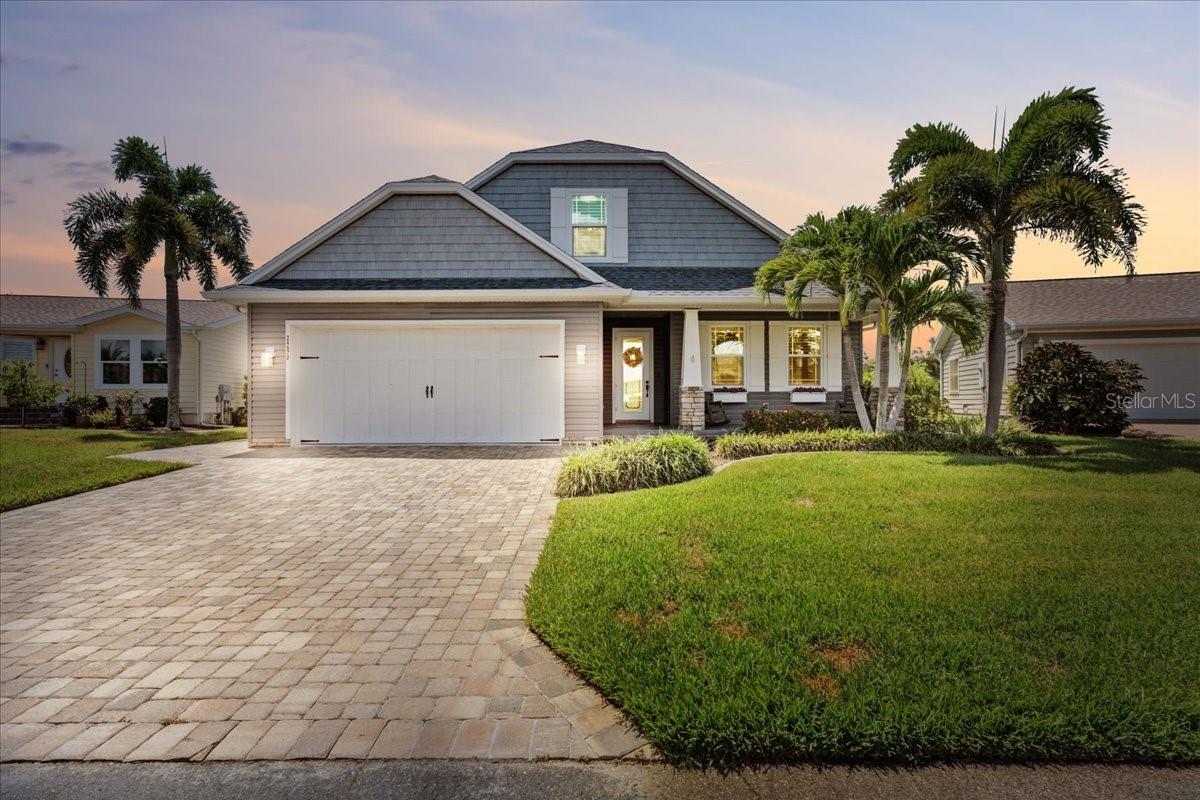 Welcome to Rio Villa Lakes – a sought-after gated 55+ community in beautiful Punta Gorda! This impeccably maintained custom built 3-bedroom, 3-bathroom home sits on an expansive oversized lot and offers over 2,700 sq ft of thoughtfully designed living space with high-end finishes and custom upgrades throughout. Enjoy a bright, open floor plan featuring pine hardwood flooring throughout the main living areas, bedrooms, and upstairs. The heart of the home is a chef’s dream kitchen, complete with propane gas stove, wine cooler, plenty of cabinetry, and a large center island—all opening to the spacious living room with a cozy wood-burning fireplace and elegant plantation shutters throughout. Step outside to your own private retreat! The covered patio features a full bar and an in-ground spa. As well as an outdoor composite deck with built-in grill—perfect for entertaining or relaxing in comfort. This home is built for peace of mind and efficiency with Hurricane impact windows and sliding glass doors, Whole-house generator connected to propane tank, Pelican whole-house water filtration system. Additional highlights include a split-bedroom layout, indoor laundry room, attached 2-car garage, and ample storage space. Located in the maintenance-free Rio Villa Lakes community, residents enjoy access to a clubhouse, heated pool, fitness center, pickleball courts and social activities—all with low HOA fees and no CDD. Conveniently close to downtown Punta Gorda, Fishermen’s Village, waterfront parks, boating, shopping, and dining --this home truly has it all!