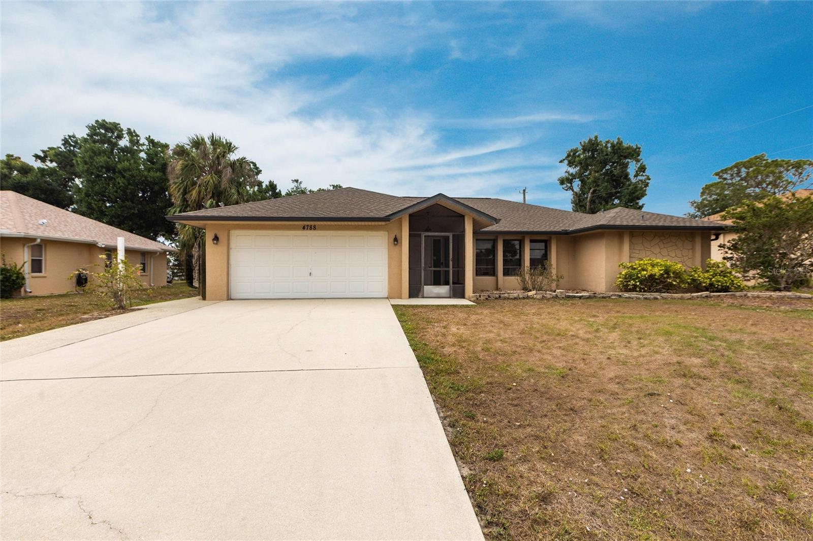 Welcome to this nicely maintained 3-bedroom, 2-bathroom pool home with a 2-car garage, offering 1,986 square feet of inviting living space—perfect for families and individuals alike. Step through the screened front entry into a welcoming foyer that opens to a spacious living and dining area, highlighted by soaring ceilings and tile flooring throughout the main living areas. The dining room features sliding glass doors leading out to a covered lanai and sparkling pool—ideal for indoor-outdoor living. At the heart of the home is the thoughtfully designed kitchen, complete with granite countertops, an abundance of Shaker-style cabinets and drawers, a breakfast bar, and a cozy breakfast nook. Stainless steel appliances add a modern touch, while pantry closets offer ample storage. The kitchen seamlessly overlooks the family room, which boasts beamed cathedral ceilings, creating an open and airy atmosphere. Designed with a split floor plan, this home offers enhanced privacy with the primary suite thoughtfully positioned on one side. The spacious primary bedroom features private access to the pool, cozy carpet flooring, and two generous walk-in closets. The en-suite bathroom is a relaxing retreat, complete with a soaking tub, dual-sink vanity, walk-in shower, and a convenient linen closet. On the opposite side of the home, two guest bedrooms each include their own walk-in closets and share a full guest bathroom, making it an ideal layout for both family living and hosting visitors. Step outside to a covered lanai equipped with ceiling fans, creating a comfortable space to relax or entertain. The expansive 35x34 screened-in area overlooks a sparkling pool and a fully fenced backyard, offering privacy and plenty of room to enjoy the outdoors. This home also includes a dedicated laundry room with a utility sink and extra storage for added convenience. Located in a desirable and established North Port neighborhood, it’s not in a flood zone and has no HOA, giving you peace of mind and added flexibility. Enjoy easy access to I-75 and Tamiami Trail, with top-rated beaches, golf courses, public boat ramps, shopping, dining, and entertainment just minutes away.
3D INTERACTIVE VIRTUAL TOUR ASSOCIATED WITH THIS LISTING**