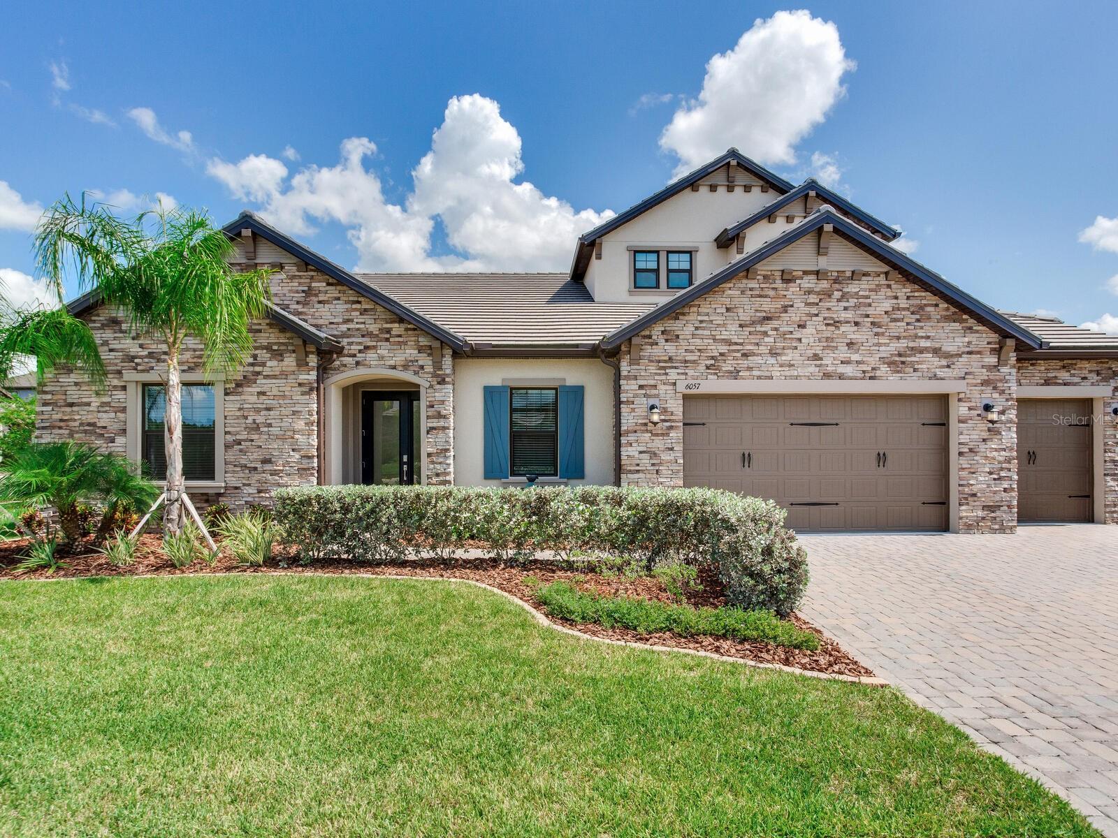 Welcome to refined Florida living at 6057 Marsh Trail Drive, nestled within the exclusive, gated community of Tarramor Estates in Odessa. This 2023-built, modified Amberly floor plan offers 5 bedrooms, 4 baths, and 3,615 square feet of beautifully designed living space—all set on a spacious .28-acre lot with peaceful lake views.
From the moment you arrive, the curb appeal is undeniable. A barrel tile roof, full gutters, California Color Package, coach lighting, and lush professional landscaping frame the home, while a full-lite, obscure glass front door offers a warm welcome.
Step inside to soaring 10-foot ceilings, wood-like tile flooring, and a seamless, open-concept layout. The heart of the home is the designer kitchen, featuring Level 4 Calcutta Gold Silestone countertops, GE stainless steel appliances, a 36” gas cooktop, built-in wall oven and microwave, 42” Alpine-painted cabinetry with crown molding, soft-close drawers, custom pull-outs, and an apron-front farmhouse sink. A full-height custom backsplash and an oversized island with ample seating complete the space. The large walk-in pantry with ventilated wood shelving is a chef’s dream.
A formal dining room is perfect for entertaining, while sliders from the main living area open to a covered patio overlooking the lake—offering ample backyard space for a future pool.
The flexible floor plan includes a dedicated flex space ideal for a home office, gym, or playroom, plus thoughtfully placed Frosted Glass Solid Core barn doors for added privacy.
The owner’s suite is a true retreat with a tray ceiling, dual custom walk-in closets, and a spa-inspired bath. Relax in the oversized garden soaking tub or rejuvenate in the semi-frameless glass-enclosed shower with dual shower heads, including a rain feature. Dual vanities with Level 4 Silestone countertops and upgraded cabinetry complete the suite.
The home’s split-bedroom design offers privacy for all. Two bedrooms off the foyer share a Jack-and-Jill style bath, while a separate bedroom has its own private bath. Upstairs, a versatile fifth bedroom with a full bath and designer walk-in closet awaits—perfect as a guest suite, media room, or home office.
Additional features include a 3-car garage with epoxy floors, a laundry room with sink and cabinetry, whole-home LED recessed lighting, 15 SEER Carrier HVAC, tankless water heater, Low-E dual pane windows, CAT 5 and USB outlets, Sensi programmable thermostats, a Ring doorbell, and MyQ smart garage technology.
Tarramor residents enjoy resort-style amenities: a heated pool, state-of-the-art gym, and an elegant clubhouse. Zoned for top-rated A-rated schools: Hammond Elementary, Martinez Middle, and Steinbrenner High—plus convenient access to shopping, dining, golf, beaches, Tampa International Airport, and downtown Tampa.
Best of all, this home sits in Flood Zone X with no flood insurance requirement and no CDD fees.
Don’t miss your opportunity to own this move-in-ready, meticulously upgraded gem in one of Odessa’s premier gated communities.