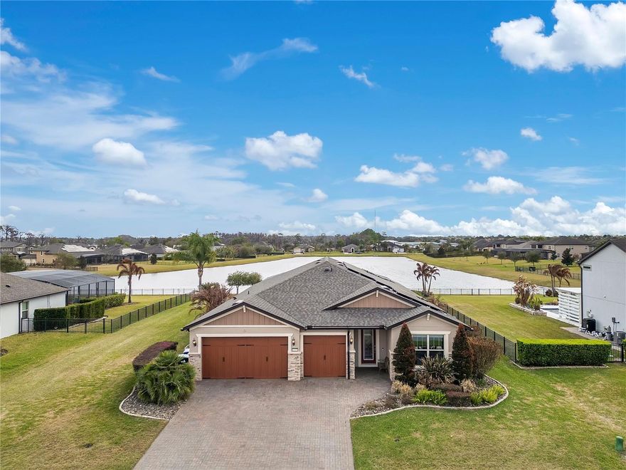 RARE FIND in EAST ORLANDO.  This home is the BEST VALUE available in this area and is LOADED WITH UPGRADES. Welcome to 3369 Kayak Way, a standout opportunity in the gated community of ESTATES at LAKE PICKETT.  Sitting on an oversized near HALF ACRE LOT, built in 2018, this METICULOUSLY MAINTAINED single-story home is spacious with a very functional layout with 3 bedrooms, a dedicated office, 3 full bathrooms, and a 3-car garage with epoxy flooring.  Enjoy the SPRAWLING OPEN FLOOR PLAN, tall ceilings, and large sliding glass doors create a bright, welcoming space designed for both everyday living and entertaining. The kitchen anchors the home with granite countertops, generous 42" cabinetry, large walk in pantry and a large island that overlooks the main living areas making it perfect for gathering with family and friends. Additional features include a 2 ZONE SURROUND SOUND SYSTEM (indoor/outdoor), water softener and a built-in central vacuum system.  This home is BETTER THAN NEW.  It has already been THOUGHTFULLY UPGRADED with PRIDE OF OWNERSHIP beaming around every corner.  The next owner (could be you) will get to ENJOY THE BENEFITS IMMEDIATELY without the wait, hassle, or additional expense.  The primary bedroom is impressively sized, offering a private ensuite bathroom retreat complete with dual vanity sinks, an oversized walk-in shower with bench seating, and a large walk-in closet.  Outdoor living truly shines here. Step onto the expansive covered lanai and enjoy a resort-style backyard featuring a SPA + SALTWATER POOL with waterfal, pavered pool deck, and OUTDOOR KITCHEN. The perfect combo for indoor/outdoor living.  With peaceful water views and spectacular sunset skies, this serves as your own private retreat.  The home also offers major upgrades that provide comfort and efficiency, including a NEW ROOF(2024), PAID-OFF SOLAR PANELS, and a WHOLE-HOME GENERATOR, keeping electric costs remarkably low (previous owners report bills never exceeding about $34). Washer and dryer are included. Residents of Estates at Lake Pickett enjoy access to the PRIVATE 763-acre Lake Pickett, including a community dock, BOAT RAMP, fishing, boating, and even VIEWS OF ROCKET LAUNCHES from the dock.  All of this while still being conveniently located with an easy commute to major highways, approximately 30 minutes to Cocoa Beach and 45 minutes to Cape Canaveral.  Homes offering this lot size, level of upgrades, water views, and private lake access rarely become available, making 3369 Kayak Way an exceptional opportunity in East Orlando.