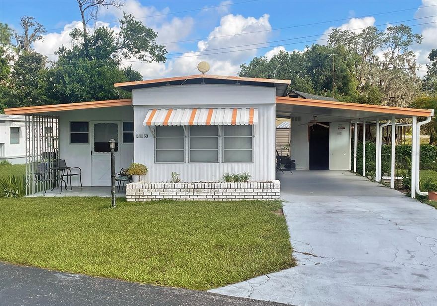Welcome to TROPICAL MOBILE HOME PARK — A 55+ Land-Owned Community in Zephyrhills! NO Lot Rent. This charming community offers the best of Florida living, perfect for year-round or seasonal residents. Here, you OWN YOUR LAND and enjoy friendly neighborhood amenities, including a clubhouse with community activities and shuffleboard. *Located near Zephyr Park. Property Highlights: *Prime CORNER LOT across from the clubhouse. *Single-Wide, 1 Bedroom / 1 Bathroom home with a covered front porch. *Bonus Room — spacious and ideal for relaxing or entertaining. *Open Living Area — well-lit living room with large windows, open to the eat-in kitchen. *Convenient Layout — hall with closet/pantry, bathroom, additional closet, and rear bedroom. *Dual Bathroom Access from both hall and bedroom. *COVERED CARPORT & Driveway Parking with side entry into the home. *Laundry/Storage Room with washer and dryer included. *Extra Storage in back. *Rain gutters with downspouts. BONUS: This home is priced BELOW a recent appraisal, making it a great value.