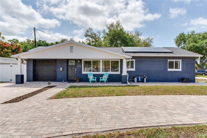 Welcome to 6688 30th Ave N, St. Petersburg — a beautifully updated 2-bedroom, 2-bathroom home situated on a desirable corner lot, offering a perfect blend of mid-century modern charm and thoughtful upgrades throughout.

From the moment you arrive, the clean lines, fresh exterior, and expansive paver driveway set the tone for what’s inside. Step through the front door into a light-filled living space where neutral tones, updated flooring, and an effortless flow create a warm and inviting atmosphere. The dining area seamlessly connects to the living room, making it ideal for both everyday living and entertaining.

The kitchen maintains its character while offering modern touches, featuring ample cabinetry, clean countertops, a new dishwasher, and a functional layout that overlooks the backyard—bringing in natural light and a connection to outdoor living.

Both bedrooms are generously sized with a clean, modern aesthetic, while the bathroom blends timeless charm with tasteful updates. Additional features include hurricane window protection, an upgraded 200-amp electrical panel (2017), a tankless water heater (2022), and a whole-house water filtration and softener system.

Major system updates provide peace of mind, including an AC system (2018) and fully paid solar panels for energy efficiency and long-term savings. The washer (2022) and dryer (2020) have been thoughtfully relocated inside the home for added convenience (2022).

Step outside to your private backyard retreat, where a charming gazebo (2020) and a grill gazebo (2023) create the perfect setting for outdoor dining, relaxing, or hosting gatherings. The fully fenced yard offers privacy with plenty of room to enjoy Florida living year-round.

The spacious corner lot, dedicated laundry area, and extensive improvements throughout make this home as functional as it is stylish.

Located in the heart of St. Petersburg, you’re just minutes to the beaches, downtown, shopping, dining, and everything that makes this area so desirable.

This home is the perfect blend of character, comfort, and convenience—ready for its next owner to enjoy.