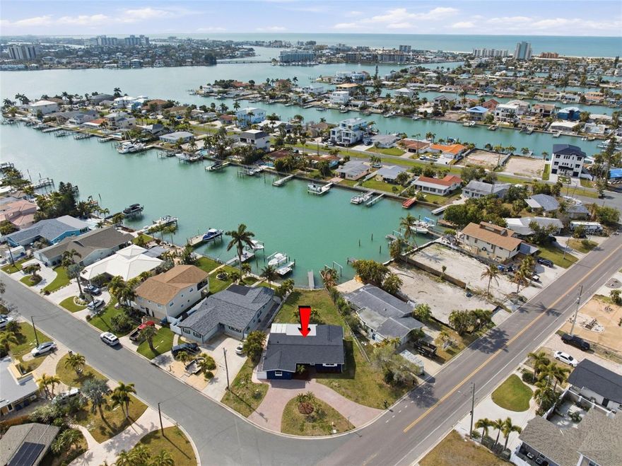 Only one mile to the beach, this beautifully renovated three-bedroom, two-bath ranch offers the perfect blend of coastal charm and modern comfort. The home features a bright open-concept floor-plan with ceramic tile throughout, creating a seamless and low-maintenance living space. A fully updated kitchen showcases all-new stainless steel appliances and opens effortlessly to the living and dining areas, ideal for entertaining. Major upgrades include a brand-new roof, new HVAC system, new water heater.  Double-paned windows are throughout for energy efficiency and peace of mind. A light-filled sunroom adds additional living space, while the indoor laundry/mud room provides everyday convenience. Step outside to enjoy a covered porch just off the kitchen overlooking a spacious backyard large enough for a future pool. The composite dock invites you to relax waterside, watch breathtaking sunsets, or catch your dinner! A large circular driveway provides ample parking for guests and gatherings. Located in the welcoming beach community of Treasure Island, you’ll enjoy locally owned restaurants featuring fresh coastal cuisine, lively bars with live music and craft beers, and a true small-town coastal atmosphere. Award-winning wide beaches host beloved annual events, including the Sanding Ovations sand sculpting festival and the international kite festival, along with a popular weekly farmer’s market. With endless activities and stunning waterfront views, this home offers more than a place to live — it’s your new life at the beach.