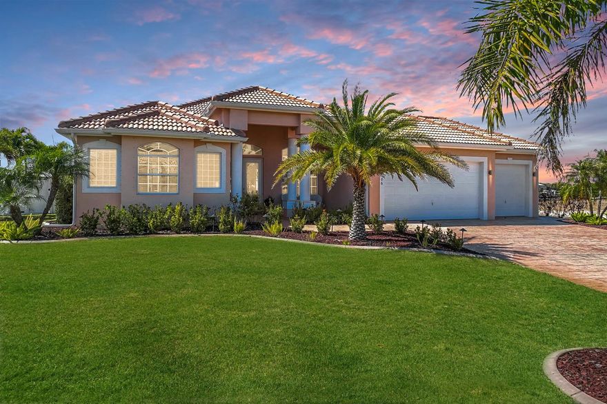 WESTERN EXPOSURE, GULF ACCESS, AND 240 FEET OF WIDE WATER VIEWS. You feel the difference when you walk in the door. Light, airy, bright, warm and inviting describes the feeling it gives you knowing that careful consideration, time and thought, went into the tasteful upgrades. Western exposure and sweeping canal frontage define this beautifully maintained Gulf access residence, positioned on an oversized lot along a 240-foot-wide canal. From the moment you arrive, the barrel tile roof (new 2023), lush local foliage, lava rock with stamped concrete border, and expansive stamped concrete driveway create a striking first impression, leading to the 3-car garage and inviting front sitting patio. French doors open to an airy interior with high ceilings, transom windows, tray ceiling detail in the family room, and tile flooring throughout. Ninety-degree and pocket sliders frame uninterrupted wide water views and extend the living space effortlessly outdoors. The kitchen is equipped with a new Whirlpool appliance package including double ovens, modern pulls, updated lighting and plumbing fixtures, and a dry bar designed for entertaining. The primary suite offers dual walk-in closets with built-in systems, a decorative fireplace, pocket sliders to the lanai, dual vanities with makeup counter, soaking tub, and a spacious walk-in shower with multiple shower heads. One guest bedroom features an en-suite bath, while another offers a generous double closet. The laundry room includes upper cabinetry, sink, and pantry storage. Outdoor living is exceptional with a saltwater heated pool featuring a waterfall, picture-window screen enclosure, and a lanai and pool deck replaced in Spring 2023 with textured matte tile. A new summer kitchen with propane grill and refrigerator enhances the space, while partial privacy fencing and Eureka palms provide natural screening. The dock is structurally sound with wrapped pilings. All mechanical systems are under six years old. Wide water views and direct Gulf access complete the Southwest Florida waterfront lifestyle. Ideally located in Southwest Cape Coral near shopping, dining, marinas, and waterfront restaurants, with convenient access to Cape Harbour, Tarpon Point, and the Cape Coral Parkway corridor, this property offers both privacy and proximity to the best of the area.