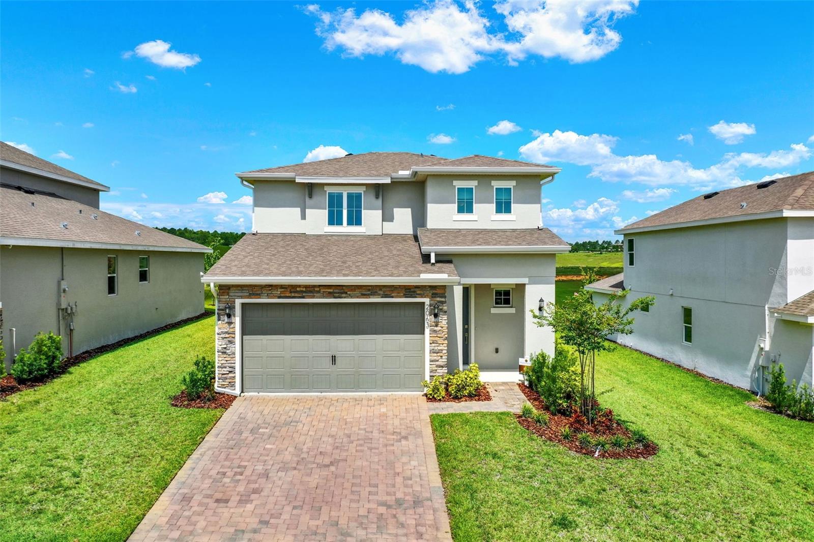 FORMER MODEL HOME from award winning Dream Finders Builder is BRAND NEW in Hills of Minneola - be the first to live in this highly UPGRADED home! This 4 Bedroom, 2.5 Bath home is stunning with quartz countertops, gourmet kitchen, custom window treatments, plank style tile, and so much more! The Primary Bedroom is on the main level while a loft and three additional bedrooms upstairs give your family and guests plenty of space.There are no rear neighbors so you can enjoy privacy from your back porch and lawn. Enjoy convenient resort style living in one of Orlando's hottest and fastest growing areas! The community features clubhouse, fitness center, swimming pools, playground, sports courts, dog park and so much more! Dining, shopping, a brand new hospital and access to 429 - great quality of life location!