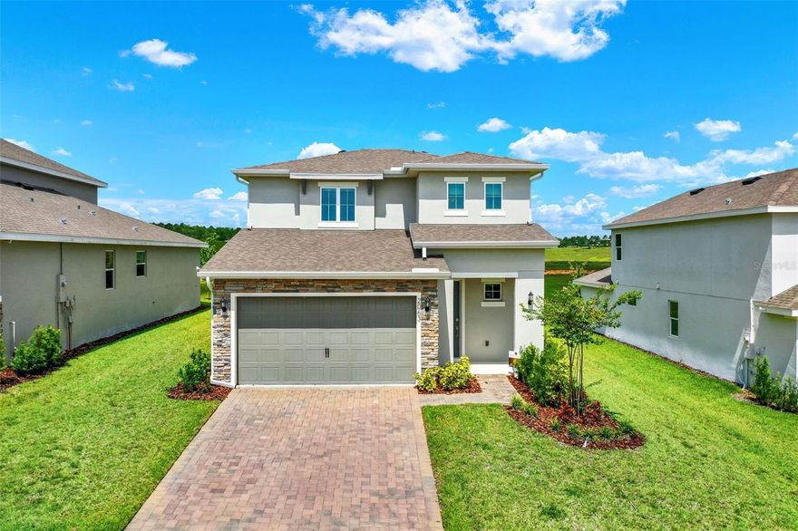 FORMER MODEL HOME from award winning Dream Finders Builder is BRAND NEW in Hills of Minneola - be the first to live in this highly UPGRADED home!  This 4 Bedroom, 2.5 Bath home is stunning with quartz countertops, gourmet kitchen, custom window treatments, plank style tile, and so much more! The Primary Bedroom is on the main level while a loft and three additional  bedrooms upstairs give your family and guests plenty of space.There are no rear neighbors so you can enjoy privacy from your back porch and lawn. Enjoy convenient resort style living in one of Orlando's hottest and fastest growing areas! The community features clubhouse, fitness center, swimming pools, playground, sports courts, dog park and so much more! Dining, shopping, a brand new hospital and access to 429 - great quality of life location!