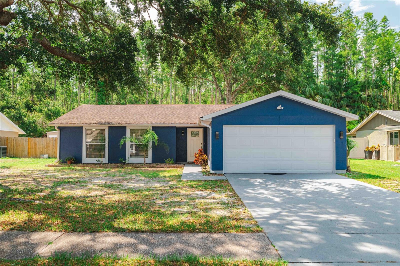 Improved price ... Opportunity knocks — and it's packed with upgrades, non-flood zone, and zero HOA fees! This 3-bedroom, 2-bath, 2-car garage home offers the perfect balance of style and convenience. Home saw significant updates, including new tile flooring throughout, removal of popcorn ceilings with a knockdown finish, fresh interior paint, crown molding, and elegant 5" baseboards. Large Living/Dining room combo with open kitchen fully equipped, granite countertops, and modern cabinetry making meal prep a delight. Featuring a dedicated office space, it’s perfect for working from home, creating, or simply having a quiet retreat. Laundry area was relocated to a room for greater convenience and open spaces. The exterior received a fresh coat of paint, along with painted driveway and walkway surfaces. Also gutters with guards were added. In the garage, door was updated with a 20-year spring, you'll find pull-down attic stairs, and also an added A/C vent for comfort. The kitchen is full equipped with granite countertops, and modern cabinetry making meal prep a delight. Outdoors, enjoy an open patio perfect for grilling and a fenced backyard with a wooded view, providing both privacy and tranquility. This beautifully home is truly move-in ready – just bring your suitcase and settle in. Located close Excellent Schools, Restaurants/Shopping, medical facilities, USF, major attractions, golf courses, airports-you’ll be perfectly positioned to enjoy it all. Don't miss the opportunity to make this home yours. Schedule your private showing today!