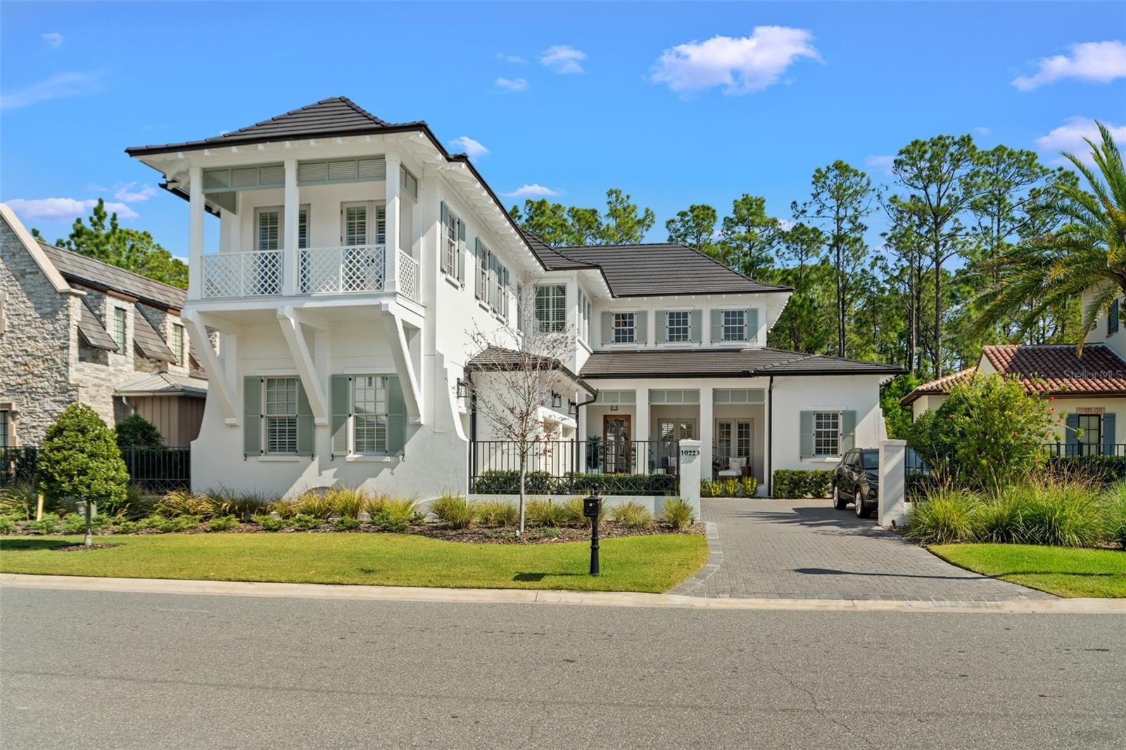 Celebrating timeless island-resort elegance with modern flair, this masterfully created West Indies luxury home inside Symphony Grove sets the standard for a casual and inviting lifestyle. Featuring 4,241 square feet of living space including an expansive 20x27 foot Great Room, exquisite first-floor master retreat, secondary bed and bath, attached guest quarters (5th bedroom) or home office with separate entrance, 23x20 foot upstairs loft, and two additional ensuite bedrooms upstairs. Owner’s bath is elegant and private with marble flooring, inviting shower with glass door and custom-created inset tilework plus sprayer, double vanities, and freestanding tub. Retractable screens open to reveal a sparkling pool just beyond the patio decking with Travertine floors and summer kitchen. With conservation behind, enjoy additional privacy with no rear neighbors. Situated within the enclave of Symphony Grove, a private gate for golf carts or bikes allow easy access to Disney’s Fort Wilderness Resort. Golden Oak at Walt Disney World® Resort is a residential resort community where families can live in the embrace of luxury, privacy, and the magic of Disney. This gated community features distinctive neighborhoods of magnificent homes, expansive natural preserves, and inviting amenities—including access to Golden Oak’s private clubhouse, Summerhouse, with superb food offerings served in a casually elegant dining room, courtyards, pool area, fitness facilities, and family room. In addition, residents have access to Club Life, Your Special Connection to the Magic, including access to the Golden Oak Member Services team, park transportation, signature club events, theme park experiences, and much, much, more. Also at Golden Oak is Four Seasons Resort Orlando at Walt Disney World Resort, which hosts an 18-hole Tranquilo golf course, full-service spa, meeting facilities, and superlative restaurants.