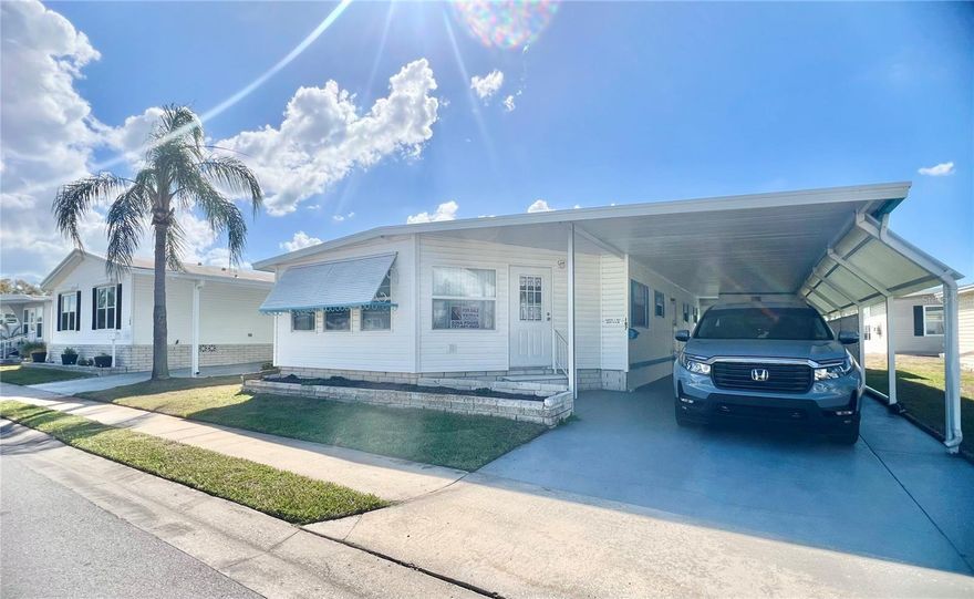 Enjoy easy Florida living in this light, bright, and beautifully maintained home ideally located with great proximity to all community amenities. This inviting property features an aluminum roof-over, newer windows in the Florida room and select areas of the home, and a previously updated kitchen and bathrooms with spacious walk-in showers, completed just a few years ago. Relax and take in the peaceful lake views from both the front Florida room and the back patio, creating the perfect setting for morning coffee or evening unwinding. The home is well maintained and being sold fully furnished, making it truly move-in ready for its next owner. Additional highlights include an extended driveway for extra parking, and an oversized shed that houses the washer and dryer with plenty of additional storage space. The home has already completed inspections, offering added peace of mind to buyers. Please note this sale will require probate, with an anticipated closing timeframe of approximately 4–6 months. This is a wonderful opportunity to secure a well-cared-for home with lovely water views and fantastic community access. Residents enjoy resort-style amenities including a private 9-hole par-3 golf course, a scenic 5-acre lake, two pools with hot tubs, shuffleboard courts, and an impressive 19,000+ square-foot clubhouse completed in 2022 featuring a ballroom, fitness center, library, card room, billiards room, and over 50 social activities annually. The low monthly fee of $420 (2026) includes water, sewer, lawn care, pest control, trash removal, high-speed internet, and more than 220 Spectrum TV channels. Optional golf memberships are available to residents and renters for just $470 per year. Whether you’re searching for a winter retreat or full-time Florida living, this exceptional property offers outstanding value, many upgrades and a vibrant 55+ community lifestyle.