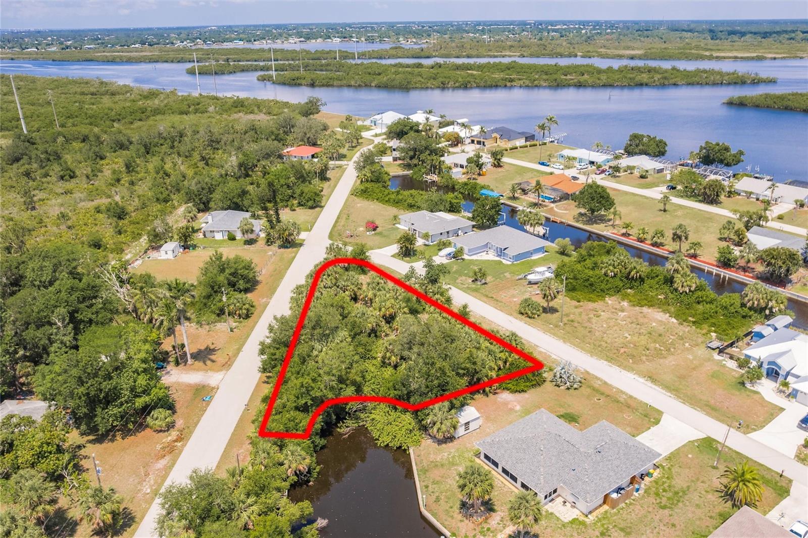 Own Your Slice of Tropical Paradise in Punta Gorda! Seize the opportunity to own this beautiful 0.34-acre waterfront lot in the highly desirable Palm Shores community of Punta Gorda, Florida—nestled between Ft. Myers and Sarasota in scenic Southwest Florida. Punta Gorda offers the perfect mix of relaxation, recreation, and convenience. Extra-large corner lot with 55' of water frontage. Located just minutes from the harbor in a charming boating community with just over 200 residential home sites, this lot offers quick access to the Gulf with only two 40+ ft. bridges along the way. Enjoy the tranquility of a quiet cul-de-sac surrounded by custom homes in an established neighborhood with no HOA fees. The property sits above street level and features mature landscaping, providing a beautiful setting for your dream home. According to county records, no scrub jays are present on the lot at the time of listing. Close to shopping, schools, parks, churches, and area attractions, this lot is priced below market value—a rare opportunity you don’t want to miss!