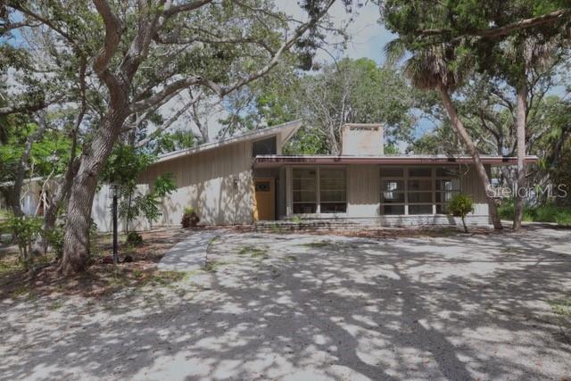 Exceptional opportunity on TWO buildable lots just 15 houses from Siesta Key Beach and a leisurely stroll from the village. The existing midcentury durable concrete block 3br/2ba home features pecky cypress siding and beamed ceilings. There is an additional free standing guest cottage. The home was impacted by last years storms, but has been stripped to the studs and is waiting for someone to put their finishing touches on it. Tremendous potential awaits. Restore and renew the existing structure or tear down and build your own tropical dream home. Investors may want to take advantage of the 2 lot configuration to develop TWO stunning residences. Plans and competitive pricing for new construction are available. Whether you delight in renovating this iconic midcentury gem, start fresh with a custom built masterpiece, or take advantage of the terrific investment opportunity of TWO buildable lots, this is a terrific opportunity to realize your dream in this desirable coastal paradise.