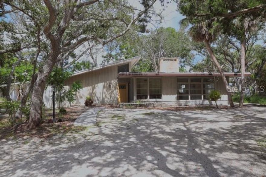 Exceptional opportunity on TWO buildable lots just 15 houses from Siesta Key Beach and a leisurely stroll from the village. The existing midcentury durable concrete block 3br/2ba home features pecky cypress siding and beamed ceilings. There is an additional free standing guest cottage. The home was impacted by last years storms, but has been stripped to the studs and is waiting for someone to put their finishing touches on it. Tremendous potential awaits. Restore and renew the existing structure or tear down and build your own tropical dream home. Investors may want to take advantage of the 2 lot configuration to develop TWO stunning residences. Plans and competitive pricing for new construction are available. Whether you delight in renovating this iconic midcentury gem, start fresh with a custom built masterpiece, or take advantage of the terrific investment opportunity of TWO buildable lots, this is a terrific opportunity to realize your dream in this desirable coastal paradise.