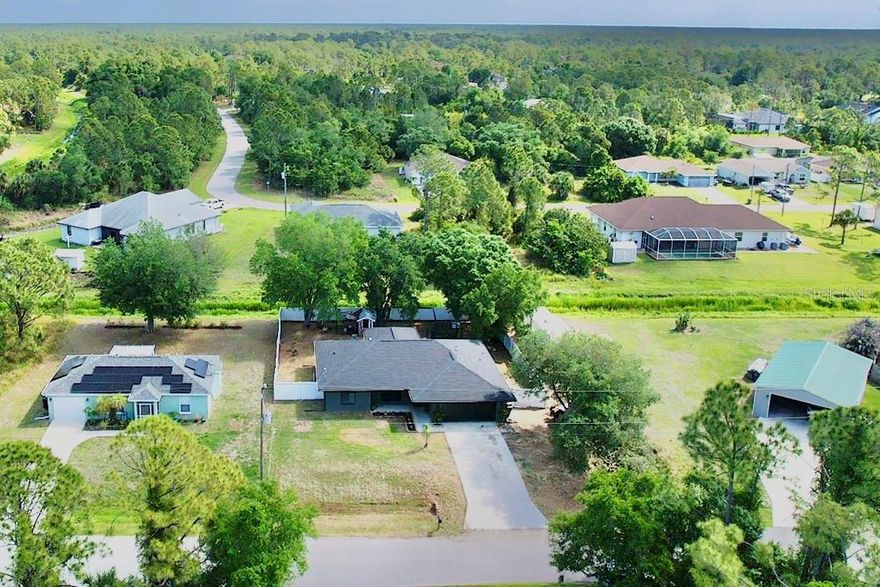 Welcome home to this beautifully maintained 3-bedroom, 2-bathroom property with a 2-car garage, perfectly situated on a spacious .24-acre lot with a fully fenced backyard for added privacy. This home offers a peaceful setting while still being just minutes to the interstate, shopping, and local schools. Inside, you’ll find a well-appointed kitchen featuring granite countertops, tile backsplash, and stainless steel appliances. The guest bedrooms boast newer carpet, while the guest bathroom has been tastefully updated with newer flooring and a vanity. The primary suite offers a walk-in closet and a walk-in shower for comfort and convenience. Step outside to relax on the lanai and enjoy the serene surroundings, with a shed providing extra storage. City Water!! With a newer 2023 roof and thoughtful updates throughout, this home is move-in ready and a must-see!