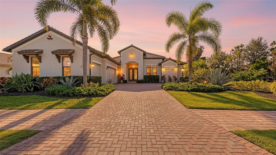 Set in Lakewood Ranch's Country Club East, this exceptional Arthur Rutenberg custom-built residence enjoys a premier south-facing homesite with sweeping lake and scenic golf course views, offering rare privacy with no visible neighbors on either side. Built with hurricane-impact windows and doors and designed for seamless indoor–outdoor living, the home features living-room sliders and dramatic zero-corner pocket sliders at the dinette that fully open to the lanai—blending the interior with a spectacular outdoor space that includes a beautiful saltwater pool, spa, built-in gas fire pit, and outdoor kitchen. Inside, tray ceilings enhance the open kitchen appointed with stainless steel appliances, a center island, hidden walk-in pantry, and gas cooktop. The spa-inspired primary suite offers glass-door access to the lanai along with two separate vanities, a spacious walk-in shower, soaking tub, linen closet, private water closet, and dual walk-in closets. Two guest rooms are thoughtfully set apart for privacy, and additional flexibility comes from a bonus room with sliders to the lanai and a private office with double glass-door entry. Well-appointed throughout and filled with natural light, this home is a true gem in one of Lakewood Ranch’s most desirable communities. Additional features include Sonos system, plantation shutters, tankless water heater, landscape lighting, maintenance-free living and so much more. Lakewood Ranch is the number one best-selling, multigenerational community in the country and located near world-class shopping, dining, entertainment of Lakewood Main Street, University Town Center, downtown Sarasota and is minutes to I-75, beaches, great schools and medical facilities. Membership to the Lakewood Ranch Golf and Country Club is optional.