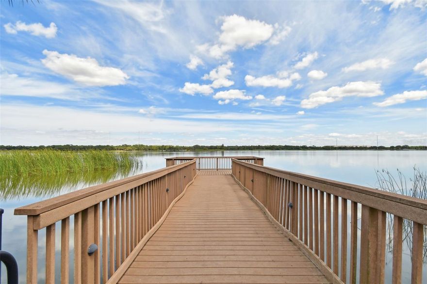 Live the Resort Lifestyle in this conveniently located -all age- Gated Community. Property is situated on Gorgeous Lake Seminole and is close to all shopping and Beaches. A True 3 Bedroom, 2 full Bathrooms with 2040 sq ft, featuring an oversized balcony with beautiful views of the pond and pool facing east. This is an end unit adjacent to the stairway with quick access to the assigned covered parking space. Plenty of Guest parking. Private dock on Lake Seminole, Pool and Gym. Pet friendly: 2 permitted no size limit (owners only) 2021 updates include Water heater, NuvoH20 Water Softener, Whirlpool Refrigerator, Whirlpool double oven range, Granite Countertops in the Kitchen and Bathrooms, Recessed lighting in the Kitchen, Murphy bed with built in cabinets in 3rd bedroom, Smart thermostat, Smoke detectors, 2 new ceiling fans with remotes and stackable washer dryer combo. Additional updates include Built in Laundry cabinet (2022) Garbage Disposal (2022) Samsung quiet dishwasher (2024) Microwave (2024) HVAC (2017) serviced semi annually. New Crown Molding everywhere and a New step in Tub with seat for easy access for those bubble baths in the primary bathroom. NO FLOOD INSURANCE