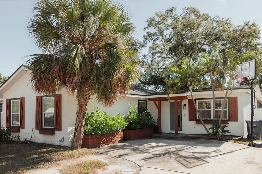 Discover the South Tampa home you've been waiting for—beautifully updated (2021), thoughtfully designed, and truly move-in ready. This gorgeous 3 bedroom, 3 bath residence with an additional  spacious den/office. This home offers a seamless blend of comfort, style, and functionality. This house DID NOT FLOOD and is in flood zone X and does not require flood insurance !

From the moment you arrive, the welcoming exterior features custom wood accent shutters, window boxes, and raised landscaping beds, along with a covered front porch that sets the tone for what’s inside. Step through the front door and into an inviting open-concept living space with cathedral ceilings, a wood-encased beam, and abundant natural light. The living and dining areas flow effortlessly into the completely renovated kitchen, boasting quartz countertops, soft-close custom cabinetry, stainless steel appliances, and a stunning tile backsplash—all updated in 2021.

The thoughtful layout includes a bonus den/office near the front entry, perfect for working from home or creating an additional flex room. The primary suite features a vaulted ceiling, dual walk-in closets, and a luxurious ensuite bathroom with a double vanity and a custom tile walk-in shower. A second bedroom also includes its own ensuite bath with updated vanity, tub/shower combination, and modern finishes. The third bedroom offers generous space and easy access to the remodeled guest bathroom.

French doors lead from the living area to the large screened lanai, an ideal spot for relaxing or entertaining while overlooking the expansive, fully fenced backyard. With plenty of room for a pool, outdoor kitchen, or additional storage, this outdoor space invites endless possibilities. A dedicated storage shed is located on the side of the home for added convenience.

Major upgrades provide peace of mind, including newer roof, electrical systems, plumbing, HVAC (2021), hot water heater (2021), and impact windows, French doors & front door (2022).

Located just minutes from Bayshore, Picnic Island, MacDill AFB, Ballast Point Park & Pier, Downtown, and major roadways, this home offers unbeatable access to shopping, restaurants, entertainment, and everyday conveniences.

This South Tampa gem has it all—beauty, function, and modern updates throughout and a large oversized lot. Don’t miss your chance to make this exceptional home yours.