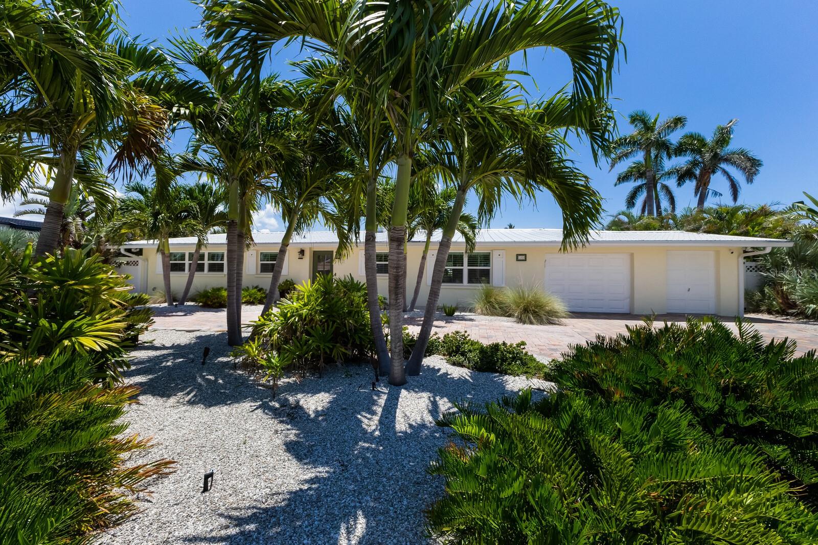 Set along a tranquil canal in the heart of Anna Maria Island, this stunning retreat offers the best of Florida living with its blend of comfort, functionality, and tropical elegance. With three spacious bedrooms and three beautifully appointed bathrooms, this home is designed to impress, featuring expansive sliding glass doors that flood the open-concept living area with natural light and offer seamless access to the private backyard oasis. The kitchen is a standout with sleek finishes, stainless steel appliances, a center island for gathering, a custom dry bar and a striking copper sink that adds a touch of artisan character. The interior features a split bedroom plan offering an easy flowing floor plan with a grand master suite, separate dining space, interior laundry room off the garage and so much more. Outside, the backyard is an entertainer’s dream with a sparkling pool and spa surrounded by lush landscaping, multiple seating areas, and direct access to Tampa Bay where a 16,000 lb boat lift and low maintenance dock awaits for effortless days on the water. The garage not only offers ample storage but also includes dedicated space for your golf cart, while clever built-ins and overhead storage racks keep everything neatly in place. Impact windows and doors, newer metal roof and more give extra piece of mind. Whether you're dining indoors with views of the water, lounging poolside under the palms, or heading out by boat from your dock, this home invites you to slow down and savor the island lifestyle in comfort and style. Don’t let this perfect slice of island life slip away!