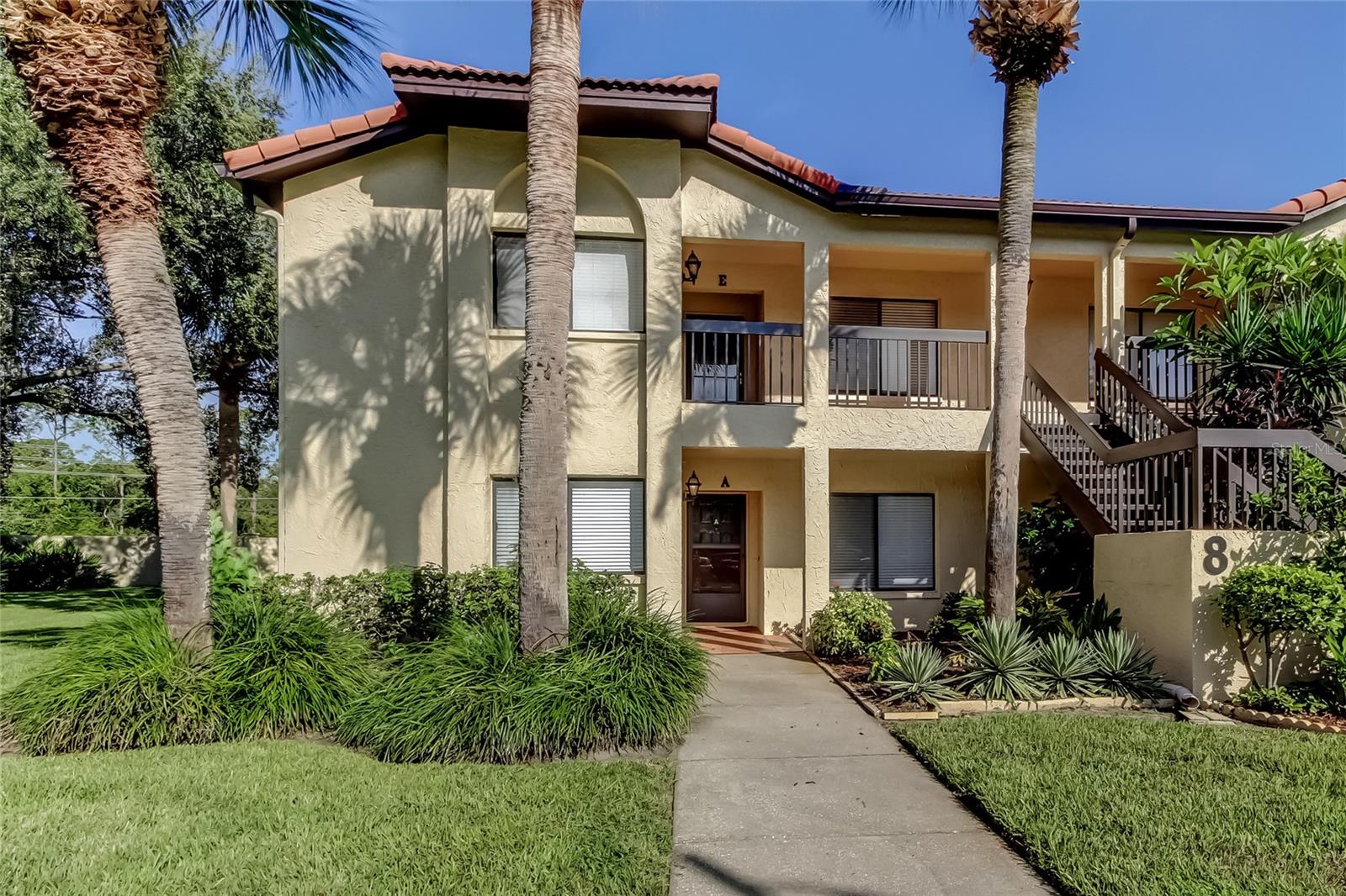 Welcome to El Pasado Condominiums, a quiet, well-maintained community nestled in the heart of the desirable East Lake corridor of Palm Harbor! This rarely available ground-floor, end unit offers the perfect combination of privacy, natural beauty, and modern comfort. Step inside to a bright and spacious 2-bedroom, 2-bathroom home featuring a split-bedroom layout, ideal for privacy and functionality. The open-concept living and dining area flows seamlessly into a charming eat-in kitchen, complete with stone countertops & ample cabinetry. The in-unit laundry includes a washer and dryer for your convenience. The primary suite offers generous space with a walk-in closet and en-suite bath with double sinks. Step outside to your private lanai, where tranquil views of the lush conservation area create a peaceful retreat—no rear neighbors! Additional highlights: covered, assigned parking + plenty of guest parking, no stairs – true first-floor living, maintenance-free lifestyle with community covering exterior, landscaping, trash, water, cable, internet, and community pool. Located just across from John Chestnut Sr. Park and minutes to Lake Tarpon, top-rated schools, golf courses, shopping, and beaches. This well-maintained condo offers excellent value in a prime location.