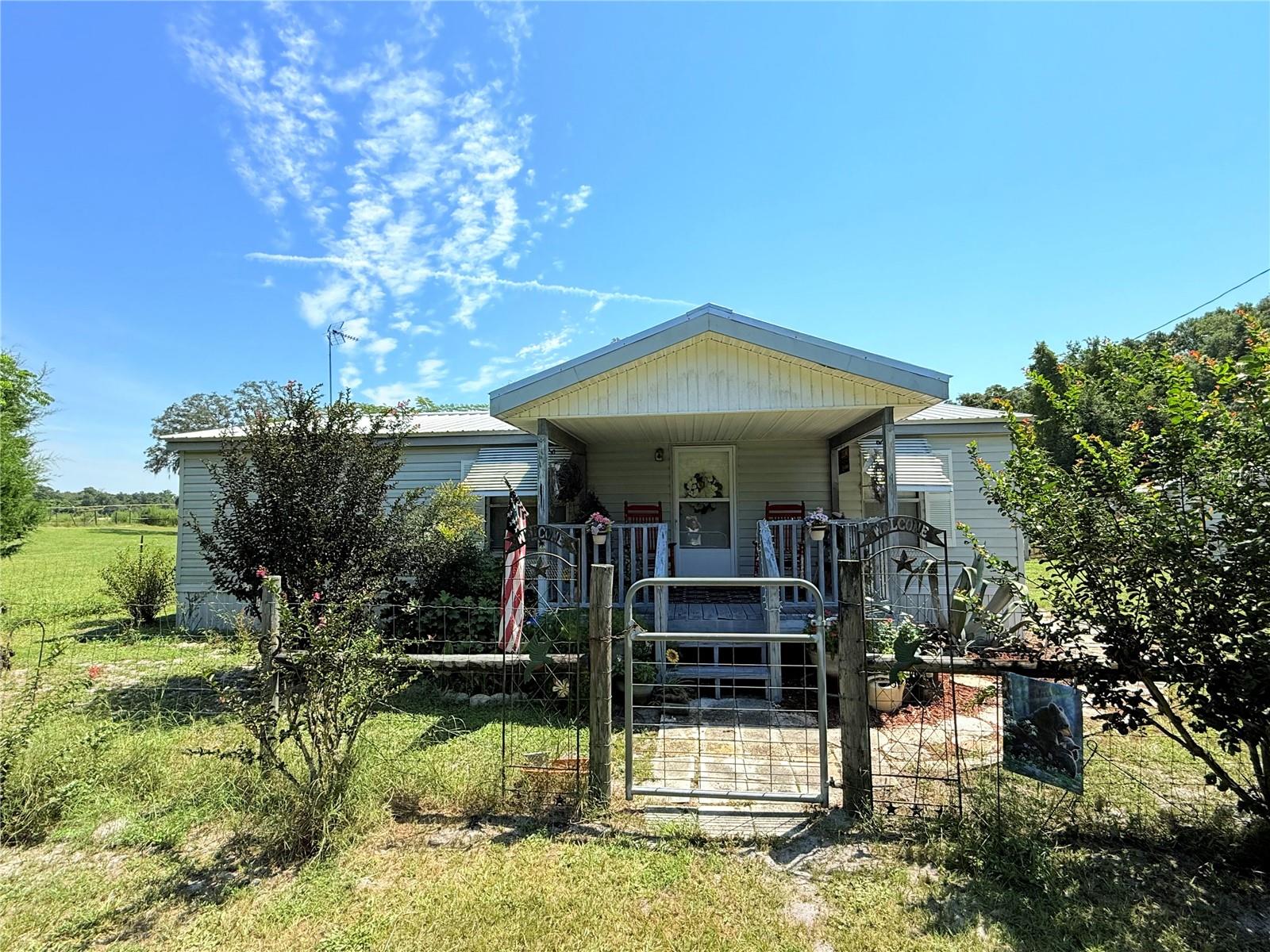 Beautiful 2 bedroom/2 bathroom on 4.88 acres located in gorgeous Dixie County. This property is completely fenced and cross fenced and currently has horses on it, as you approach the property you'll see the private gated driveway lined with crepe myrtles and loops to the home. The home is cozy and has an open floor plan. A nice open living room, dining room and kitchen with all updated appliances. Two master bedroom suites, each with combo tub/showers. Outside you have (2) detached carports perfect for parking all vehicles and toys as well as 3 sheds perfect for storage/workshop as well as a 3 stall horse barn. Accepting cash or conventional loans. Call today for YOUR tour!