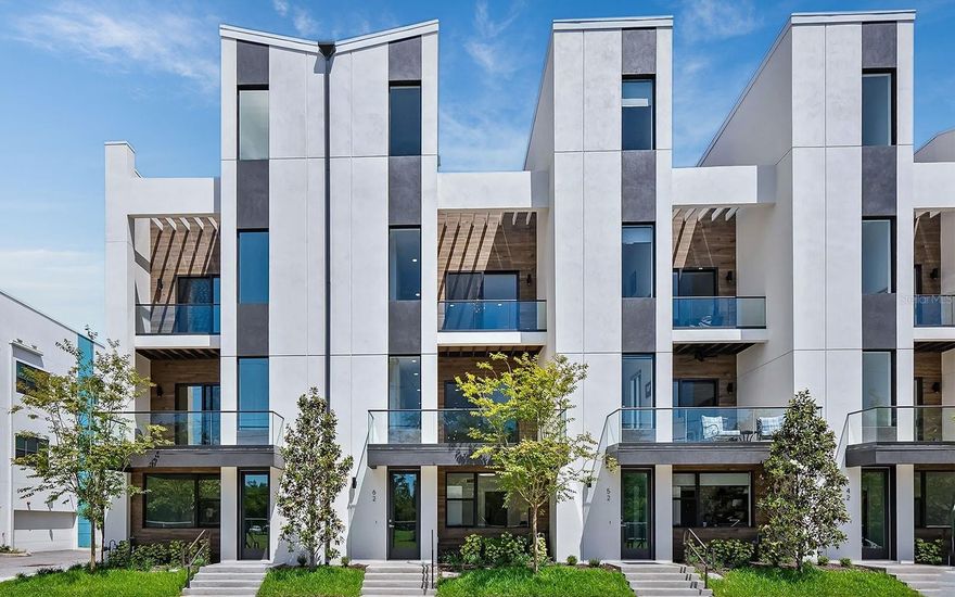 Nearly new four-bedroom luxury townhome in Sarasota’s vibrant uptown district, located on upper Main Street for easy access to the city’s renowned galleries, cafes, restaurants and boutiques. This exceptional location places you minutes from pristine beaches, championship golf, the hospital, airport and top cultural venues. The property sits adjacent to the northern end of the Bay Runner trolley, providing complimentary rides to downtown, St. Armands Circle and Lido Beach.

This stunning 2,763 square foot residence comes completely turnkey furnished with designer-selected finishes throughout. The smart four-level floor plan maximizes both privacy and entertaining space, featuring a private elevator, double-concrete construction, high ceilings, eight-foot interior doors, energy-efficient systems, hurricane-rated impact windows, multiple balconies, finished rooftop, and parking for four vehicles in the two-car garage plus attached carport.

The ground level offers a private guest suite perfect for visitors or additional income. The main second level presents an open floor plan connecting the kitchen, dining and living areas. The gourmet kitchen delights with sophisticated European cabinetry, quartz countertops, under-cabinet lighting, a center island with waterfall feature, and high-end Samsung and Bosch stainless steel appliances. The third level houses three bedrooms and two baths, including the primary suite which boasts an outdoor balcony, walk-in closet and luxurious ensuite bath. The crown jewel is the finished rooftop level designed for outdoor living, featuring multiple gathering spaces, an outdoor kitchen, jetted spa, and glass railing with captivating city views.

Weekly rentals are permitted, and this residence has a strong, established record of successful rental performance. This home combines a prime location, exceptional design, turnkey convenience, and proven rental history for the ultimate Sarasota lifestyle.