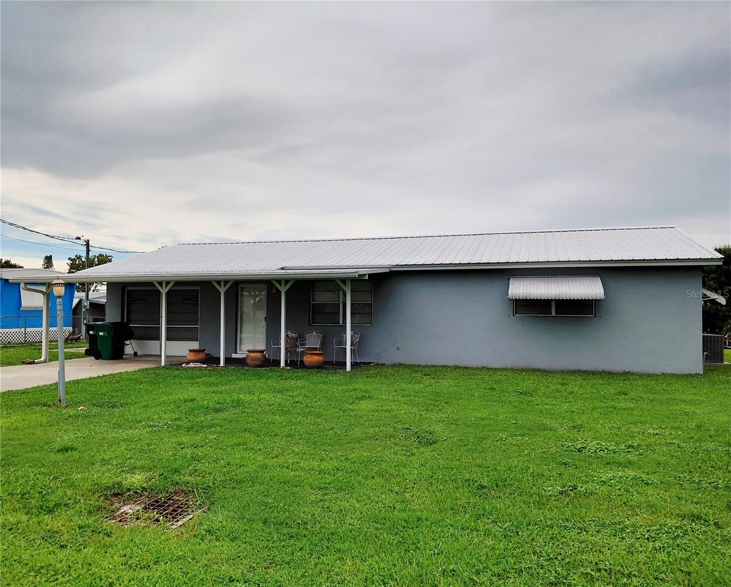 more pics coming SOON. Taylor Creek Isles. SOLD AS IS This property is 2 bed 2 bath with one car garage. Lake Okeechobee access featuring a covered boat dock with a lift. Seawall and dock built 2006. Lift will accommodate 18 foot pontoon. Access to the Taylor Creek lock is one mile away via canal. Metal roof is 3 years old. Bedrooms feature wall to wall closets. Stove is electric but is also plumbed for gas. Public water and sewer connected.