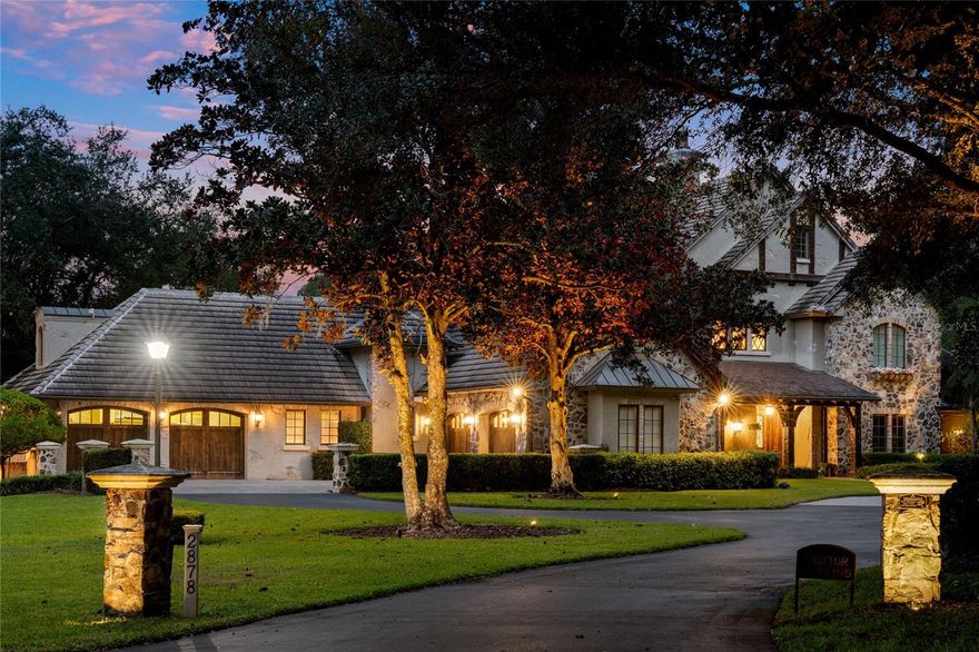 One or more photo(s) has been virtually staged. NEW PRICE! The Estate at Markham Woods is one of Central Florida’s most iconic luxury compounds. Encompassing 7.61 high & dry acres, fully fenced with electronic gates and a newly built guard house, this property features a 12,000 SF main residence, 2,300 SF guest house, 800 SF cottage, and a 5,040 SF air conditioned car barn. An irreplaceable retreat designed for multi-generational living, car collectors, entertainers, and privacy seekers.

Main Residence (12,000 SF): A European style estate spanning two levels with 6 bedrooms (5 ensuite), 8 full baths, and 3 half baths, all warmed by 5 gas fireplaces. The dramatic curved wrought-iron staircase is accented by elegant stonework, custom millwork, lighting, and a private elevator. Flexible design includes separate primary with adjacent nanny room, a library, office, hobby studio, game room, 2nd story den, gym, two laundries, pet wash station, and a whimsical tree-house lounge. The chef’s kitchen offers Thermador gas cooktop, griddle, warming drawers, Dacor double ovens, 2 Bosch Dishwashers, Subzero Refrigerator, beverage fridges, custom cabinetry, granite and stone counters, and a generous prep island, ideal for everyday living or entertaining.

Guest & Cottage Residences: A 2,300 SF guest house with 3 ensuite bedrooms, ½ bath, full kitchen, and 2 car garage provides the perfect multi-generational living quarters or private guest accommodations. A separate 800 SF cottage with bedroom, bath, kitchenette, and laundry offers direct access to the pavilion ideal for extended family or staff.

Pools & Outdoor Living: Resort-style heated saltwater pool, pavilion, gazebo, expansive lawns, plus an indoor resistance pool, spa, and steam shower create year-round leisure.

Collector’s Car Barn & Storage: A remarkable 5,040 SF, fully air-conditioned car barn with soaring 20ft ceilings accommodates 10+ vehicles and includes an office suite, half bath, and kitchenette. A new 250 gallon fueling tank streamlines vehicle service. Additional amenities include a helicopter pad/party venue space, covered RV bay with water/electric hookups, and 17 total garage spaces.
Upgrades & Infrastructure: Fiber optic gigabit internet, 5 new generators, 16 new HVAC systems, 3 new hot water heaters, new roofs on the guest house, cottage, and car barn, and a newly screened front porch enhance comfort, connectivity, and peace of mind.

A rare opportunity at this new price and unmatched in Central Florida for privacy, acreage, and turnkey luxury living.