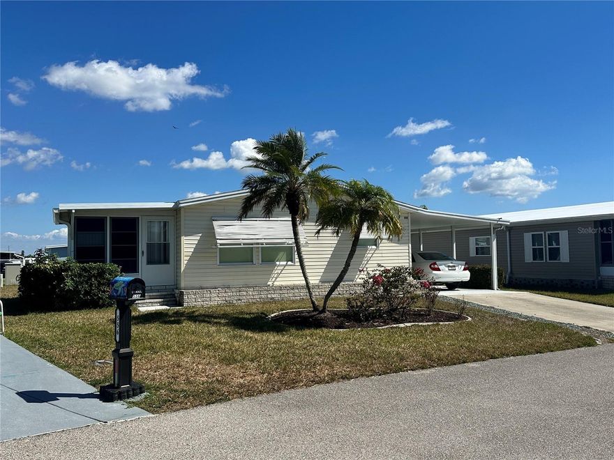 Enjoy easy Florida living in this well-maintained double-wide manufactured home in the vibrant 55+ community of Harbor Isles in North Port. Being sold furnished, this home is move-in ready and ideal for seasonal enjoyment or year-round residence. Inside, you’ll find comfortable living spaces and the added convenience of an interior washer and dryer. Both bedrooms feature spacious walk-in closets, providing excellent storage and functionality. The home has been very well cared for and is in really good condition, while some original features—including carpet and linoleum flooring—offer a great opportunity for a buyer to update and personalize to their own style. A welcoming porch provides the perfect spot to relax and enjoy the Florida breeze. Harbor Isles offers an active lifestyle with outstanding amenities, all just minutes from shopping, dining, medical facilities, and the beautiful Gulf beaches. Whether you're searching for a winter retreat or a full-time home, this property offers comfort, value, and room to make it your own.