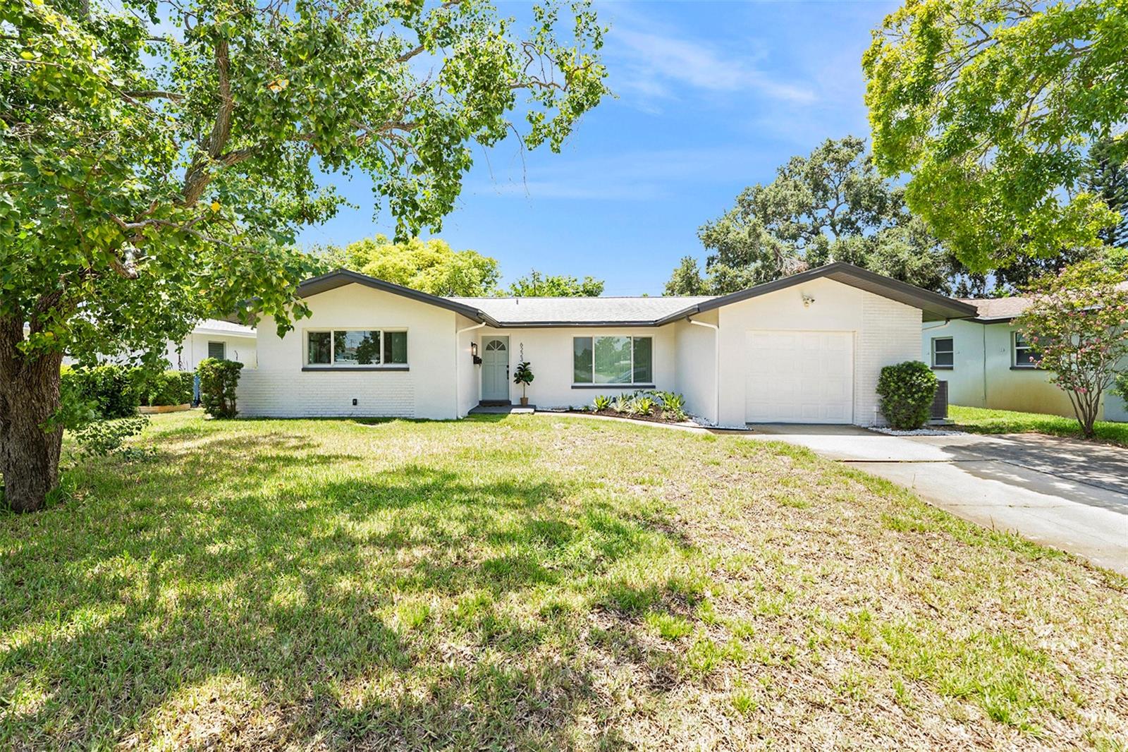 Seller offering $5,000 toward buyer’s closing costs! Enjoy the best of coastal living—without the worry - in this HIGH AND DRY charm property!. Inside, you’ll love the bright, spacious kitchen with All NEW Appliances, quartz countertops, and stylish cabinetry, along with durable LVP flooring throughout. The home features two oversized bedrooms, two fabulous bathrooms with large vanities, a generous screened lanai with an accent ceiling, multiple storage closets, and a garage with ample space. With a new AC and new water heater, this home is move-in ready and offers the perfect blend of comfort, location, and peace of mind! This charming St. Petersburg home is located in a NON-FLOOD ZONE with no HOA or CDD, offering peace of mind just minutes from the Gulf beaches, including St. Pete Beach and Pass-a-Grille. You're also just 5 minutes from the Skyway Bridge, the O'Neill's marina, Maximo Park, Skyway Beach, St. Pete Pier, and Central Avenue’s vibrant restaurants, shops, and art scene. Just around the corner, Lake Vista Park offers a dog park, walking fitness trails, and a pool!—perfect for evening strolls or weekend fun. Life the beach life!