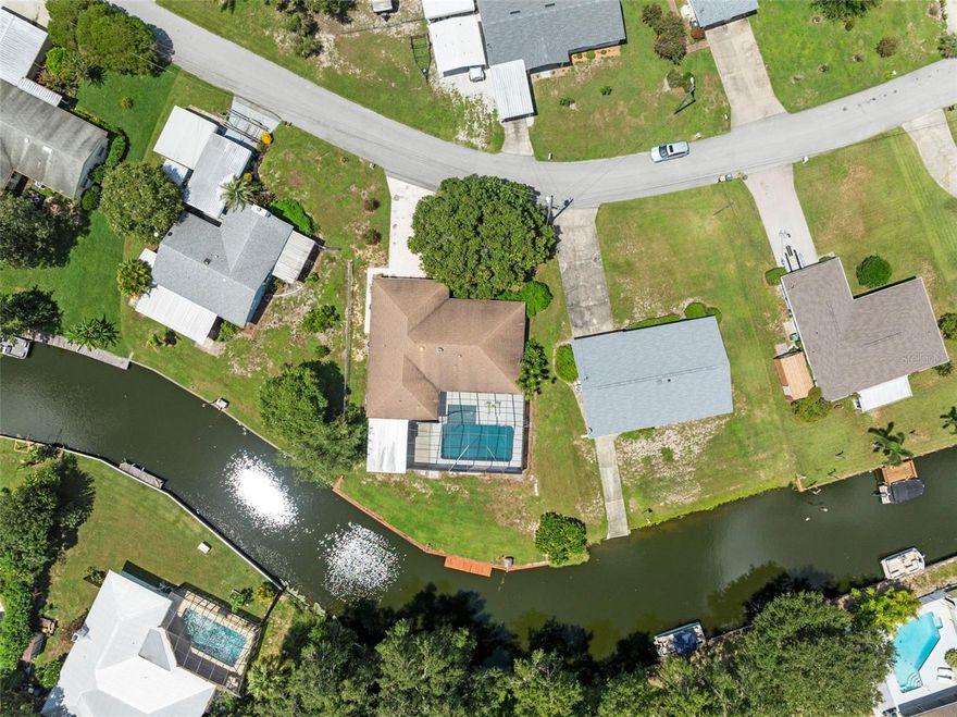 Welcome to this exceptional 4-bedroom, 2-bath pool home, perfectly situated on a premium canal-front lot with picturesque views and direct access to the serene waters of Lake Pierce.

The spacious living room is filled with natural light through large double-pane windows, while tile flooring flows throughout the main living areas for durability and easy maintenance.

The gourmet kitchen boasts white shaker-style cabinetry with brushed nickel hardware, stainless steel appliances, and a center island with quartz countertops. Pendant lighting and stylish floating shelves create a beautiful focal point, while a convenient pass-through window to the Florida room makes entertaining effortless. The formal dining room enhances the home’s elegance with custom lighting and stunning water views.

The primary suite offers a peaceful retreat with tile flooring and a private en-suite bathroom.

The Florida room, accessible through three sets of French doors, provides panoramic views of the water and pool, creating a tranquil space for relaxation.

Step outside to your private oasis. The contemporary heated pool features a lounging baja shelf and a fully screened enclosure for year-round enjoyment. A covered patio overlooking the calm canal waters is ideal for alfresco dining, and a convenient outdoor shower completes the space.

Additional highlights of this remarkable property include: Three generously sized guest bedrooms, Remodeled guest bathroom, Solid surface flooring throughout, Double-pane windows, Two-car garage, Wood dock and seawall, Pontoon boat included with the sale.

Lake Pierce spans an impressive 3,728 acres, offering premier fishing and boating opportunities. This rare property allows you to enjoy the waterfront lifestyle you’ve been dreaming of. Embrace nature and make this canal-front retreat your own! Pontoon Boat Included in the sale.

Furniture is available for purchase at an additional cost.
