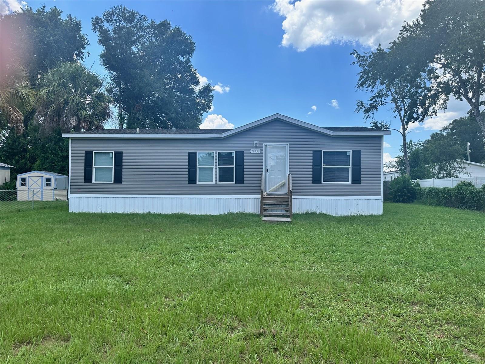 Newer Mobile home on a nice lot in Little Lake Weir Sub Close to Hwy 441 and Shopping .Home includes new Kitchen and Appliances Three Bedrooms and inside Laundry Front and Rear entry Call to view this home