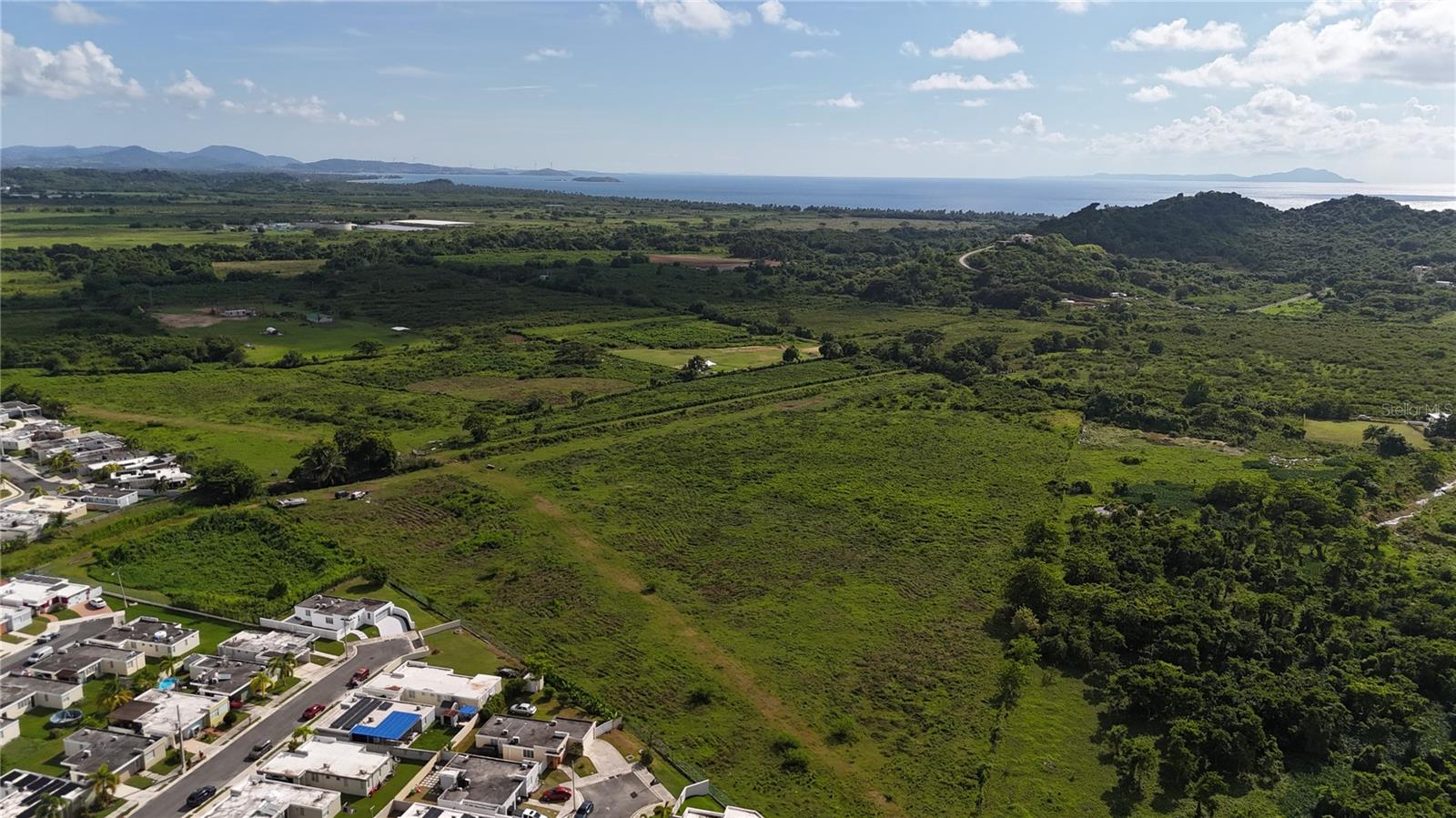 This COMPLETELY FLAT 12.2-acre RARE TO FIND lot offers prime potential for both agro-commercial, Hospitality, or residential use. A water canal runs through the center of the property, adding a unique feature and enhancing its versatility. Located just minutes from the coast, this land provides an excellent balance of tranquility and accessibility. Whether you envision an agro-commercial project, eco-lodging, warehouse, eco-touristic activities, or to develop your dream home, this property is for you. Don’t miss the chance to explore this exceptional land and bring your vision to life.