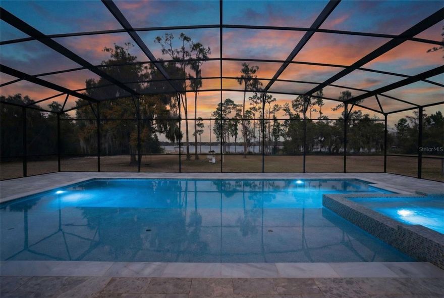 Private 5-acre lakefront estate in the gated community of Lake Hendon Reserve with over 160 feet of frontage on a spring-fed lake. Designed to maximize water views and outdoor living, the property features a newly constructed 2025 saltwater pool with 25-foot sun shelf, 16-person spa, marble pool deck, and a renovated 2025 private dock providing direct access for boating and fishing.

Located minutes from Lake Nona’s Medical City with convenient access to Narcoossee Road, USTA National Campus, SR 417, and Orlando International Airport.

Double glass entry doors open to interiors with double crown molding, 5-inch baseboards, and lake views from multiple living areas. The kitchen includes quartz countertops, oversized island with seating for six, custom cabinetry, double ovens, gas cooktop with pot filler, additional prep sink, added electrical outlets, and stainless steel appliances overlooking the water.

The family room with gas fireplace opens to a covered rear porch pre-plumbed and vented for a future outdoor kitchen. The primary suite is privately positioned in the east wing with lake views and direct porch access. The primary bath includes dual vanities, walk-in closet, and oversized shower with dual shower-heads.

Additional spaces include a dedicated home office, upstairs loft, downstairs guest bedroom, two additional upstairs bedrooms, and a 700-square-foot bonus/flex room suitable for media, game room, or additional bedroom.

Four-car garage with extended depth, insulated and climate controlled with heating and air conditioning, plus motorized garage screens. Dual HVAC systems replaced in 2021. New 2025 whole-home water filtration system, including reverse osmosis filter at the kitchen sink. Low-E windows and radiant heat barrier.



Video tour available.