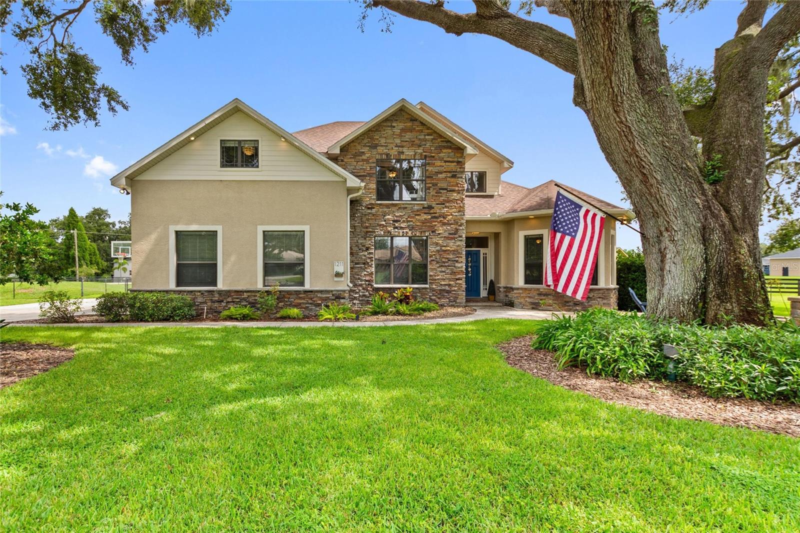 Stunning 5-Bed, 3-Bath Custom-Built Pool Home perfectly positioned on a lush .65-acre lot. Located in a small neighborhood of custom homes on large lots, this is a prime location with easy access to Winter Haven, Lakeland, I-4, The Polk Parkway, and beyond! High-end features throughout, towering ceilings, and a HUGE BONUS/MEDIA ROOM make this the perfect place to call home. Situated at the end of a cul-de-sac, the home is set back from the street for increased privacy, while the extended curved driveway and mature oak trees, paired with the home’s striking design, create exceptional curb appeal. The front porch incorporates a large paver patio with built-in seating and fire pit – the perfect place to enjoy a beautiful Florida evening. Upon entering the home you’re welcomed by soaring ceilings and a warm, inviting color palette. A versatile flex room off the entry offers endless possibilities – whether for formal living, dining, or even a home office. The living area showcases beautiful stone work, custom cabinetry and french doors that lead to the screen pool deck and lanai. The kitchen is a chef’s dream, contemporary Maple cabinetry is highlighted by a splash of color from the distinctive backsplash – an area rich with character and charm. The kitchen is also open to living and dining area, and open the doors to the pool deck to create the perfect place for entertaining. The spacious primary bedroom, conveniently located on the first floor, features a large walk-in closet and an en-suite bathroom with a dual vanity, beautifully tiled shower, and large garden tub. Two of the guest bedrooms are located on the first floor, as well as a guest bathroom easily accessible from the main living area. The second floor has two very large guest bedrooms and a guest bathroom with a trendy design. An oversized media/bonus room upstairs is great for a play room, theatre, office, 6th bedroom, or so much more – the possibilities here are endless! A walk-out attic space upstairs is a great storage space for holiday décor or other personal items that would normally take up valuable space in the garage. The stunning SALT WATER POOL, built in 2016, boasts a modern design and is complete with a spa, sun-shelf, propane heat, LED lighting, a screen enclosed paver patio, and covered seating area. The huge back yard is FULLY FENCED, adding another space for outdoor enjoyment! Additionally, a whole home water filtration and softener system adds yet another high-end amenity. This house has it all, character, high-end finishes, a beautiful pool, outstanding back yard, and more. Schedule your private showing today!