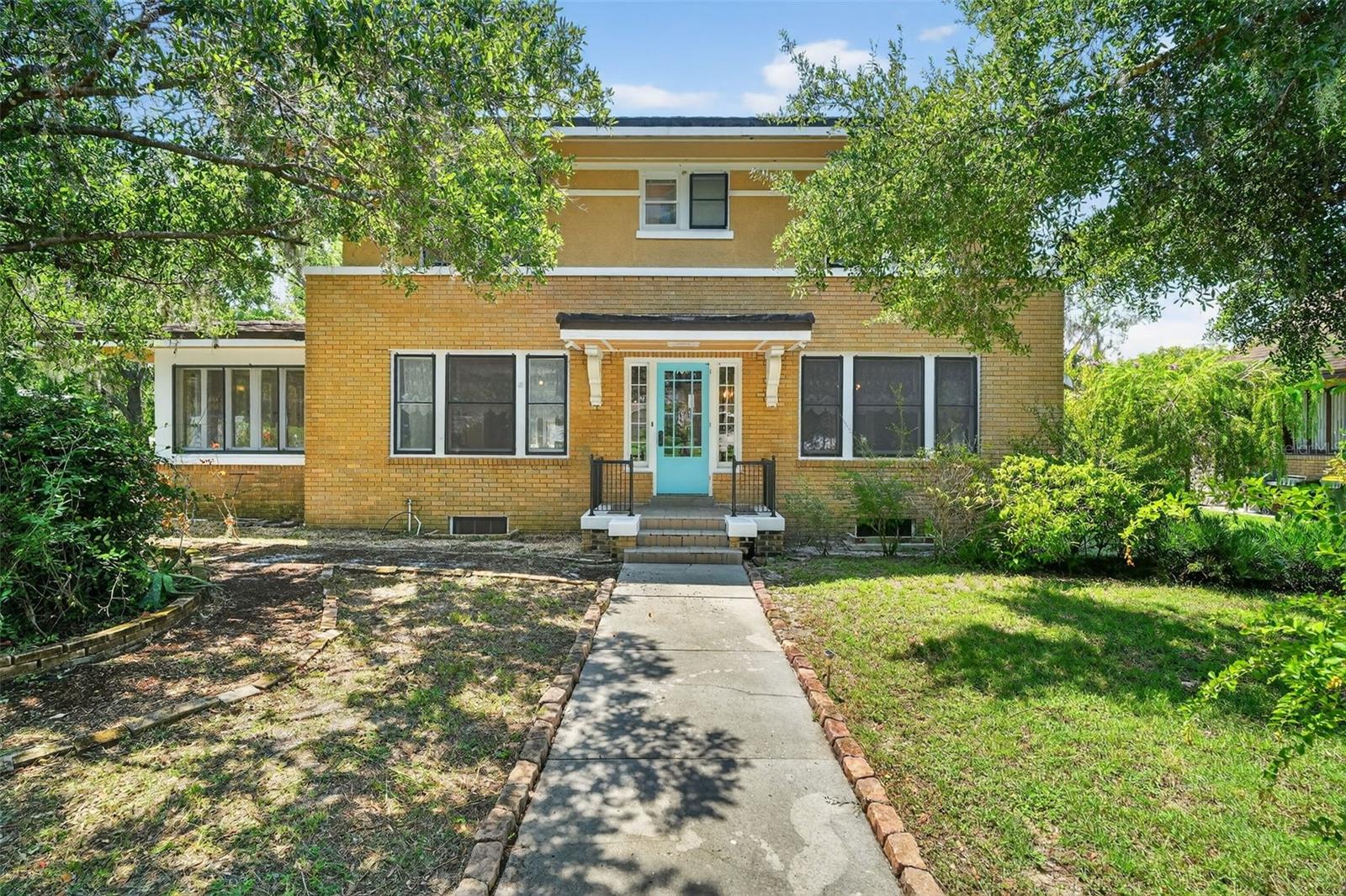 Located in Clermont's most desirable area, this classic 4-bedroom, 2.5-bath custom brick home offers a perfect blend of historic charm and modern convenience. With 2,386 square feet of living space and an additional 1,083 square feet in the basement, this home provides ample room for comfortable living. From your doorstep, enjoy easy access to hiking and biking trails that lead to the historic downtown, shopping, dining, waterfront park/beach, and rail-trail system. The home features four bedrooms and two bathrooms on the upper level, with a convenient half bath on the main floor. A spacious family room wraps around a cozy fireplace and seamlessly connects to a den/library, offering plenty of space for family gatherings. All bedrooms are located upstairs, ensuring privacy and comfort. The full basement provides room for hobbies, a workshop, and a laundry area, complete with a laundry chute connecting to each floor. The basement opens to the back driveway, which connects to the rear alley. Built to last, the home boasts 100-year heart pine flooring. Thoughtful updates have preserved its original character, with beautiful wood flooring, doors, cabinets, railings, built-ins, and light fixtures that maintain the authenticity of a bygone era while incorporating modern amenities. Outside, stepping stone paths guide you through a gardener's paradise, featuring mature shade trees, with Florida landscaping. A quaint city park and play area are conveniently located just across the street. This is a rare opportunity for the right family to own a cherished piece of history. Step back in time and embrace an "Old Florida" lifestyle, where quality and craftsmanship unite in this architectural masterpiece.