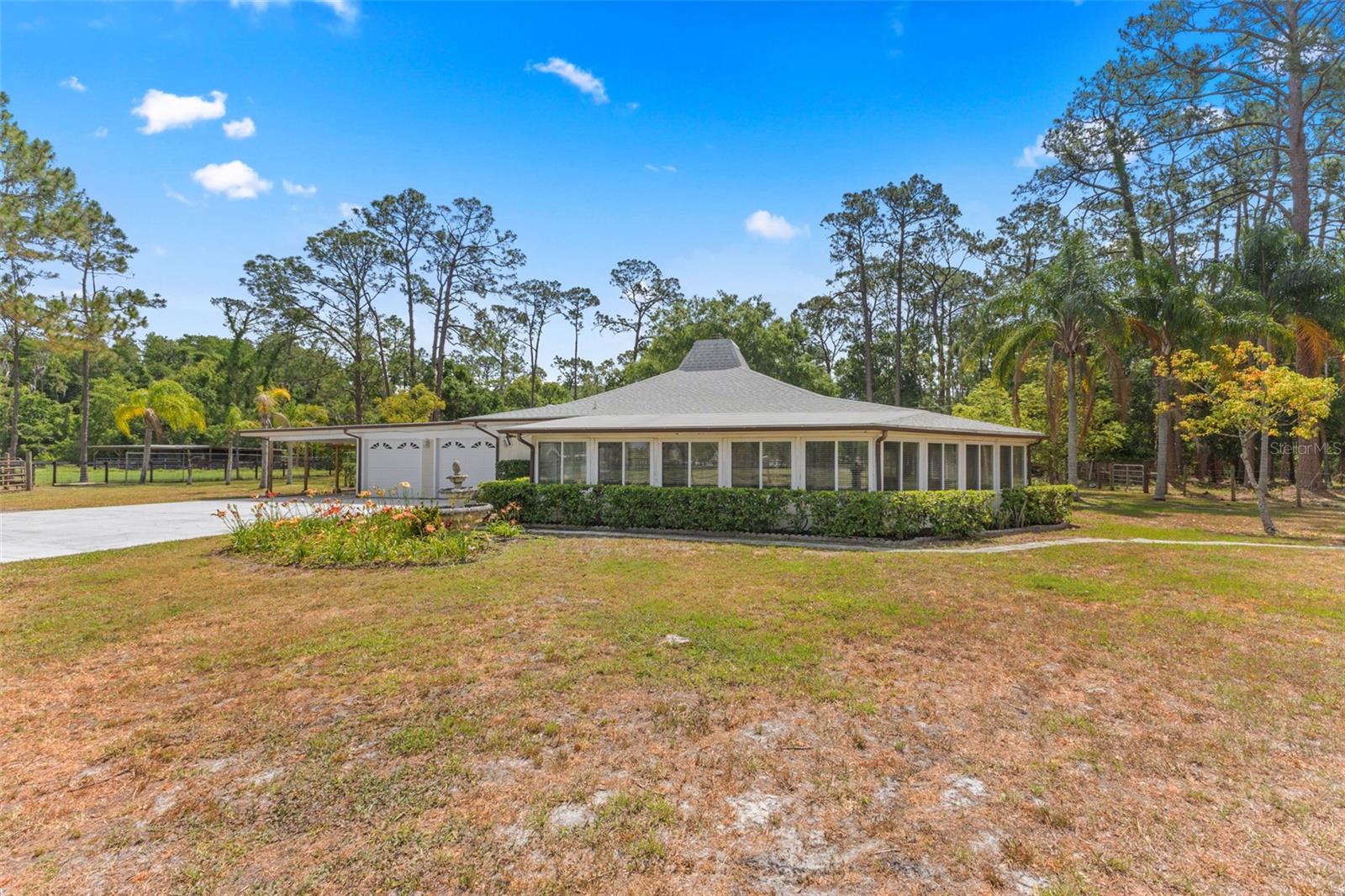 $25,000 PRICE IMPROVEMENT! OPPORTUNITY KNOCKS! Priced well BELOW APPRAISED VALUE! Welcome to your own 5 USABLE ACRES in the sought-after Keystone Ranchettes community where you are surrounded by MULTI- MILLION DOLLAR homes. Tucked away behind a private gate and surrounded by PICTURESQUE MATURE TREES, this property offers the ULTIMATE SECLUSION, serenity, and space to build the lifestyle you've been dreaming of. With no HOA or deed restrictions, you have the FREEDOM to make this land entirely your own. HIGHLY DESIRED SCHOOLS, NON-FLOOD ZONE, AND NO HOA! As you make your way down the drive, you’ll be greeted by a beautiful open pasture—ideal for horses, goats, chickens, and all the animals you’ve always wanted. Imagine waking up with your morning coffee, overlooking your land through NEWER WINDOWS, while listening to the quiet hum of nature. The 3-bedroom, 2-bathroom home is well-maintained with a NEWER ROOF (2022) and NEWER SEPTIC SYSTEM (2020), and offers a blank canvas ready for your personal touch. Step out back to enjoy the in-ground pool, perfectly positioned for PRIVACY and framed by trees. Whether you're dreaming of building a custom barn, creating a larger home footprint, or simply enjoying the wide-open land, the POSSIBILITIES here are truly endless. Enjoy the EQUESTRIAN TRAILS located just steps from your property - no trailering required! All of this—just minutes from beautiful beaches, top-rated restaurants, and perfectly situated for an easy commute in any direction. Keystone Ranchettes offers the RARE balance of PEACEFUL, rural charm with EASY ACCESS to everything Tampa Bay has to offer. Don’t miss your chance to make this ONE-OF-A-KIND property your OWN!
