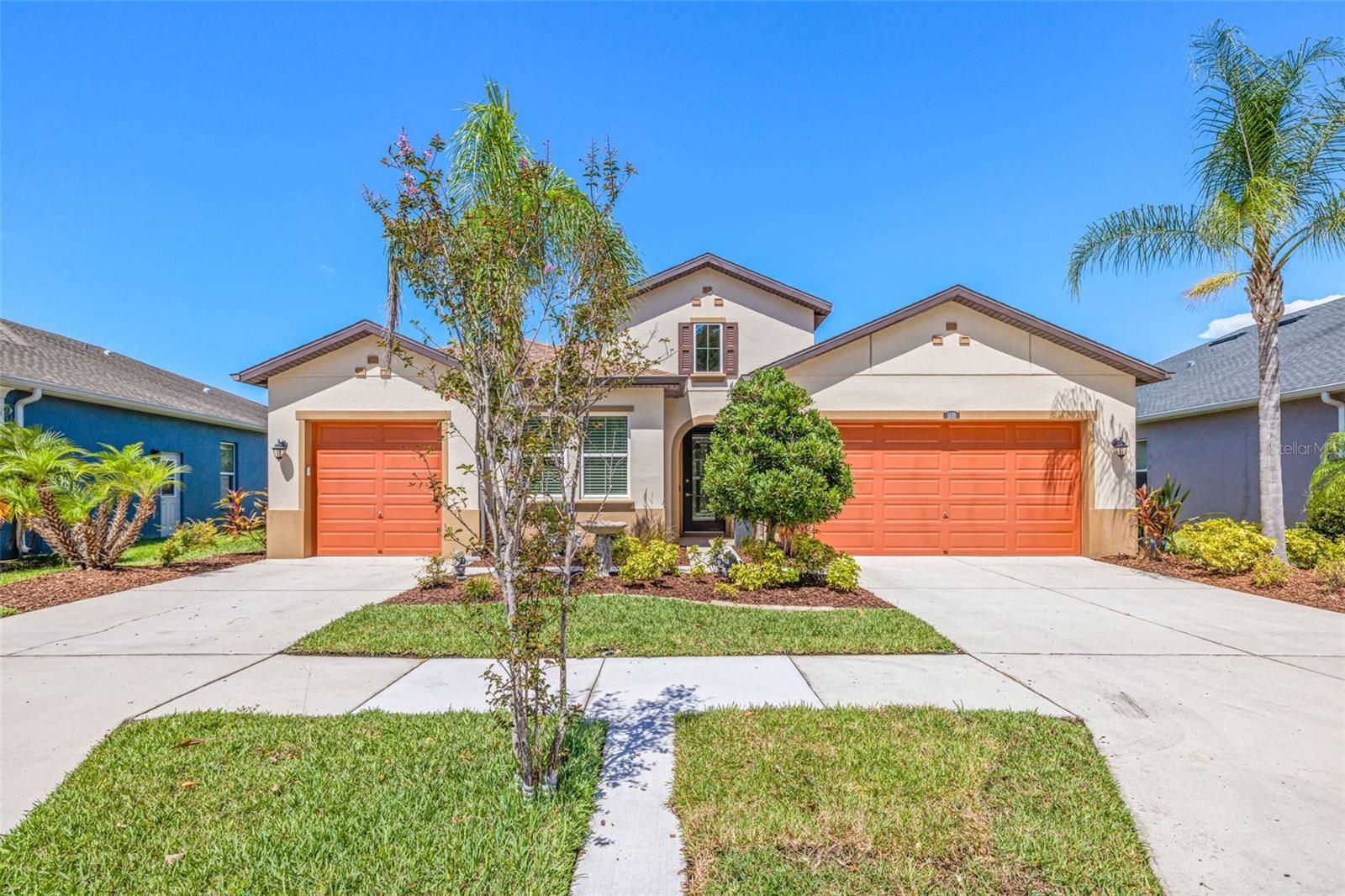 Stunning Like-New home in gated Meridian at Meadow Pointe IV with no front or rear neighbors! Welcome to this beautifully maintained, like-new 4-bedroom, 3-bathroom, 3-car garage home featuring a bright, open layout with modern finishes throughout. From the moment you arrive, you'll be impressed by the custom beveled glass front door and inviting curb appeal with custom landscaping. Step inside to discover a thoughtfully designed 3-way split floor plan with elegant crown molding, 10 foot coffered and tray ceilings, and abundant natural light. The spacious Great Room features ceramic tile flooring for easy maintenance and a sleek, contemporary feel and multiple windows with a view of the conservation and pond. The heart of the home is a chef’s dream kitchen boasting a large island, cooktop, granite countertops, stainless steel appliances, touchless faucet, walk-in pantry, and large casual dining area with room for an amply sized table. Near the Great Room is the generously sized Den/Office with French doors and tray ceiling. Found at the rear of the home is the oversized Primary Bedroom with new LPV floors, 5.25” baseboards and multiple windows. Gorgeous Primary Bathroom with matching split-vanities with stone counters, custom tile floors, frameless shower with built-in bench and separate water closet. Enormous Primary closet with multiple drawer system and convenient direct access to laundry room. There are 2 other bedrooms each with new LPV floors and ceiling fans and a hall bathroom with a shower/tub combo. Bedroom-4 features new LPV floors and ceiling fan and its very own beautiful ensuite bath. There is an adorable mud room style seating area near the entrance to the 2-car portion of the garage with bench seating and hooks ideal for hanging jackets, backpacks and sports gear. Some of the homes additional features include; 5.25” baseboards throughout, Pelican whole house water filtration system which includes a carbon filter, salt-free water softener and UV lamp, irrigation system, rain gutters, motion activated exterior lighting, fenced backyard, ceiling fans in most rooms, washer/dryer included, programmable thermostat, Ring doorbell and so much more. Seller also had insulation added above each garage during construction for extra energy efficiency. Enjoy ultimate privacy with a front and rear conservation lot offering tranquil pond views and no neighbors in sight. Relax and entertain outdoors on the custom extended lanai with a frameless design, perfect for taking in unobstructed views of the peaceful surroundings. Home also has a unique split 3-car garage set up with separate driveways. Meadow Pointe IV residents enjoy a fantastic clubhouse with recreational facilities which includes; a fitness center, sparkling pool, tennis/pickleball courts, basketball courts, park, playground and volleyball courts. Meadow Pointe is an ideal location near highly rated schools, shops, restaurants, Wiregrass Mall and Tampa Premium Outlets, three hospitals and I-75 offering an easy commute to downtown Tampa and TIA.