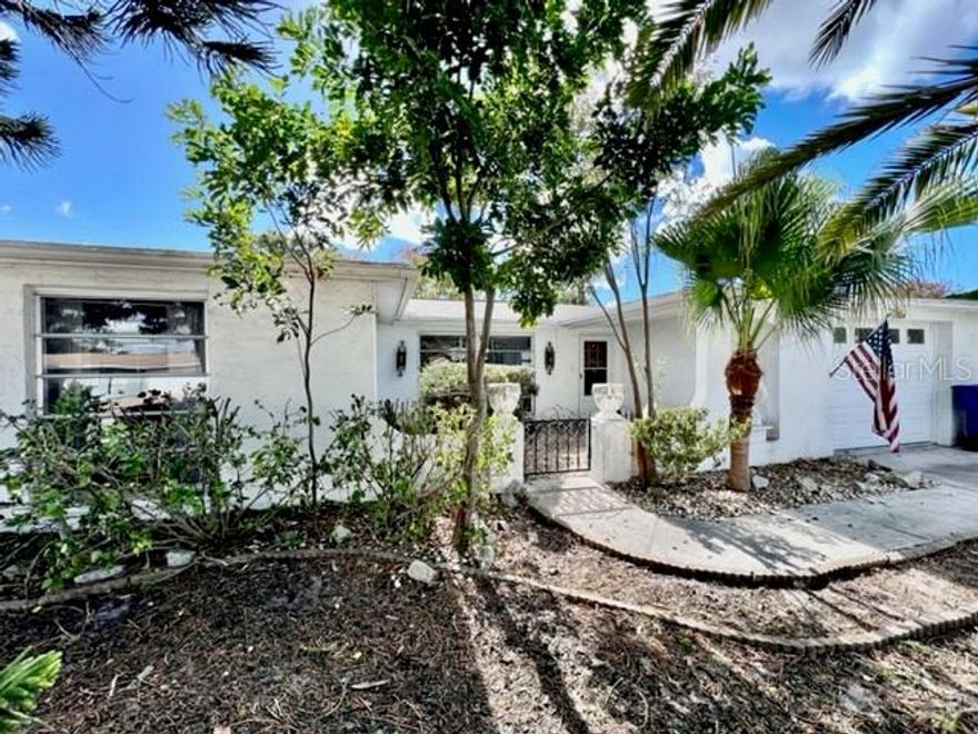 ATTENTION INVESTORS, FLIPPERS & CONTRACTORS: THIS HOME IS FOR YOU!!! This once-lovely GEM at 7024 Parrot Dr, Port Richey in the FANTASTIC community of Regency Park in SUNNY FL features 2 bedrooms, 2 bathrooms, 1 car garage in a NO HOA, NO CDD & NO FLOOD ZONE! Key exterior features are UNIQUE front elevation reminiscent of mid-century Spanish-Mediterranean style with its arches, front courtyard, rain gutters & mature tropical landscaping including BEAUTIFUL palms. The OPEN FLOOR PLAN consists of the foyer, kitchen, dinette, family, living & dining rooms. As you step inside, 1974 CLASSIC VINTAGE is what comes to mind - from the colorful carpet to the ELABORATE iron floor to ceiling railings that adorn the foyer to Brady Bunch window drapes are all reminiscent of this era. The spacious kitchen features all appliances, pantry closet, double sink & breakfast bar with a pair of RETRO pendant lights. Off the dining & family rooms are double glass sliding doors into the Florida room/lanai. In this POPULAR El Dorado model, the family room can easily be turned into a third bedroom. The primary bedroom can easily fit king size furniture, has a GENEROUS walk-in closet, ceiling fan & private bathroom with dual sinks & tub/shower combo. Located at the front of the home is the second bedroom which has ample closet space & a ceiling fan. More great features are pretty chandelier in the dining room, lots of storage options throughout the house, oversized garage & GORGEOUS thick wood etched custom front door. A COOL FACT about this house is that it has NEVER BEEN SOLD YET & has remained in the family since it was built in 1974. Naturally, the lucky buyer needs to do their due diligence; however, the electrical panel looks electrifyingly great, the water heater appears tall & stout & the AC is cooling the house. The shingle roof has been recently replaced from the original tile roof (permitted, 9/2013). This home needs cosmetic updates & this is already reflected in this price. There is a LOT OF SWEAT EQUITY IN THIS HOUSE! Can you transform it to an ELEGANT BEAUTY? The location is IDEAL near restaurants, shopping, schools, places of worship, medical plazas, beaches & tourist attractions. MAKE THIS YOUR FUTURE HOME!