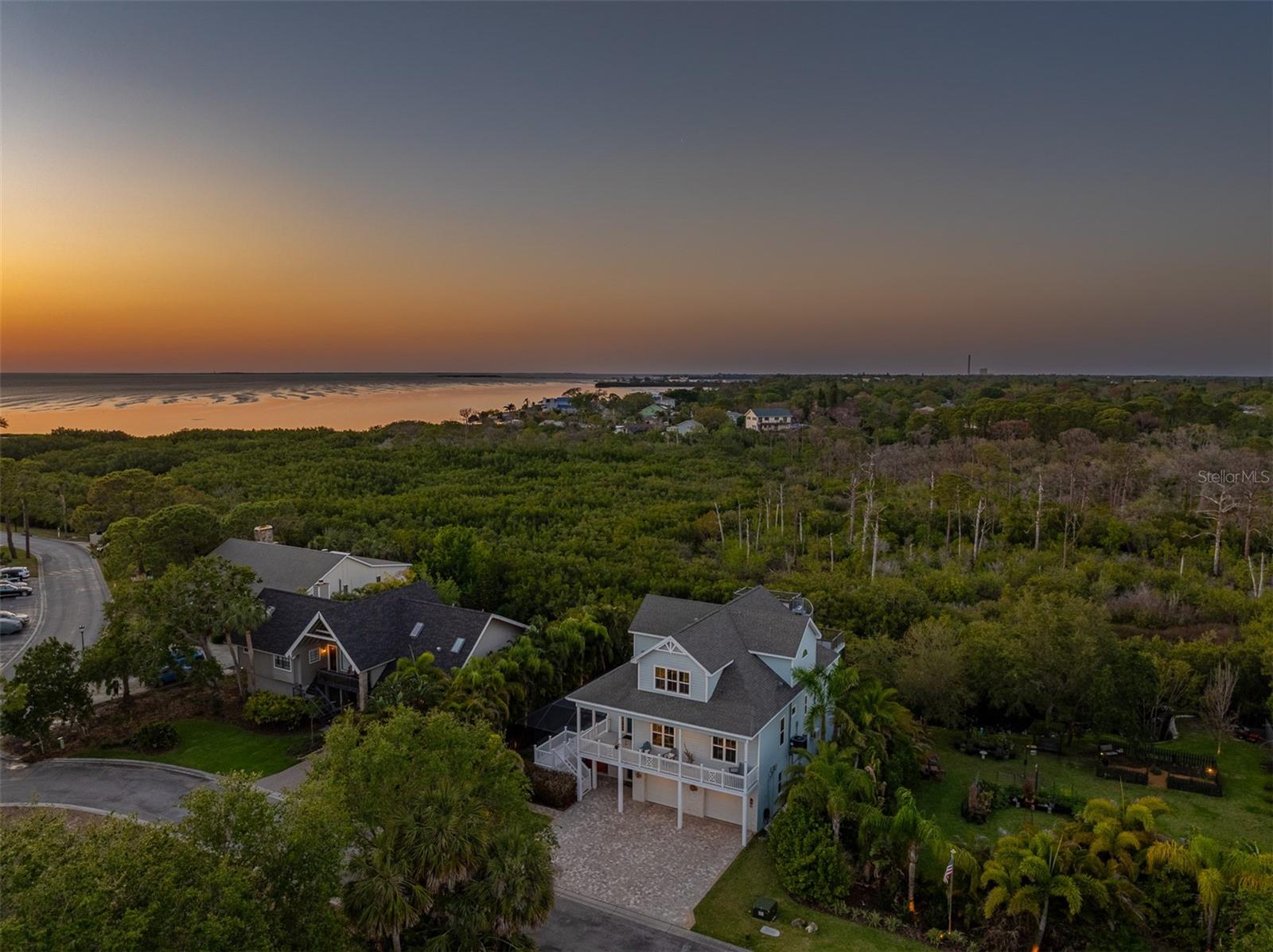Boater's Dream! Luxury Estate with Pool in Gated Mariner Village with Stunning Western Water Views, & a Private Boat Slip for your Boat! Built in 2016 to all the newest Hurricane Codes! Countless Upgrades & Stunning Water Views will have you in awe daily. Additional lushly landscaped lot (.28 Acres) directly next-door to the East that is available for purchase separately. For Boaters, this is the best of all worlds with a Private boat slip at the Community Marina just minutes by foot from your property! Don't Miss out on this elevated 4 Bed, 3.5 Bath custom-built estate offering over half an acre of privacy, space, & flexibility in the gated coastal community of Mariner Village. Love the lush tropical landscaping & water views this home offers! Pavered driveway, manicured grounds, & elegant architecture set the tone as you arrive at the property. Enjoy the charming covered front porch space as you enter the home into a soaring foyer with porcelain tile floors & abundant natural light. This home has 3 levels, and it has been built so that an elevator could be easily added. The heart of the home is a designer kitchen featuring Leathered Granite Countertops, a Lg Island, soft-close custom cabinetry, a walk-in pantry, beverage fridge, & stainless-steel appliances. The space flows into a bright dining area & a spacious great rm with a gas fireplace, custom built-ins, & sliders to the lanai—ideal for entertaining. A first-floor private office with built-ins offers flexible use (4th bedroom potential), & a guest bedroom with ensuite bath doubles as the main level guest bath. Laundry Rm with storage on this level. Upstairs, the owner’s retreat is sure to impress, with a DREAM walk-in closet w/ built-ins, & a spa-like ensuite with freestanding tub, walk-in shower, & dual vanities. French doors lead to a private covered balcony with spiral staircase access to a second rooftop viewing platform—perfect for sunsets & panoramic Gulf views. Additional guest bedroom upstairs with an ensuite + shower & single sink vanity. On the Lower Level of the home (1st Level) is even more space to enjoy. There is a bonus space (approx. 740 sq ft, not included in main square footage) that is accessible from inside or through a separate entrance and features a large multi-use room currently set up with a pool table, home theater, & gym area. Step outside to a resort-style screened lanai with paver decking, a saltwater pool, & a standalone hot tub. The backyard offers space for a playground or additional patio area, & you're just steps from launching your kayak for fishing or peaceful paddling. Features include a large 2-car garage with tall ceilings & extra storage, 4 walk-in attics for additional storage (with energy efficient spray foam insulation), some hurricane-rated windows & doors, & deep water access for large boats via a community boat slip (available to rent monthly). Launch your boat just minutes from Anclote Island, where there is some of the best fishing in the state! Located just minutes from Sunset Beach, Fred Howard Park, the Pinellas Trail, and the iconic Tarpon Springs Sponge Docks, this rare estate offers a flexible lifestyle, coastal charm, & room to grow in one of North Pinellas County’s most desirable gated communities.