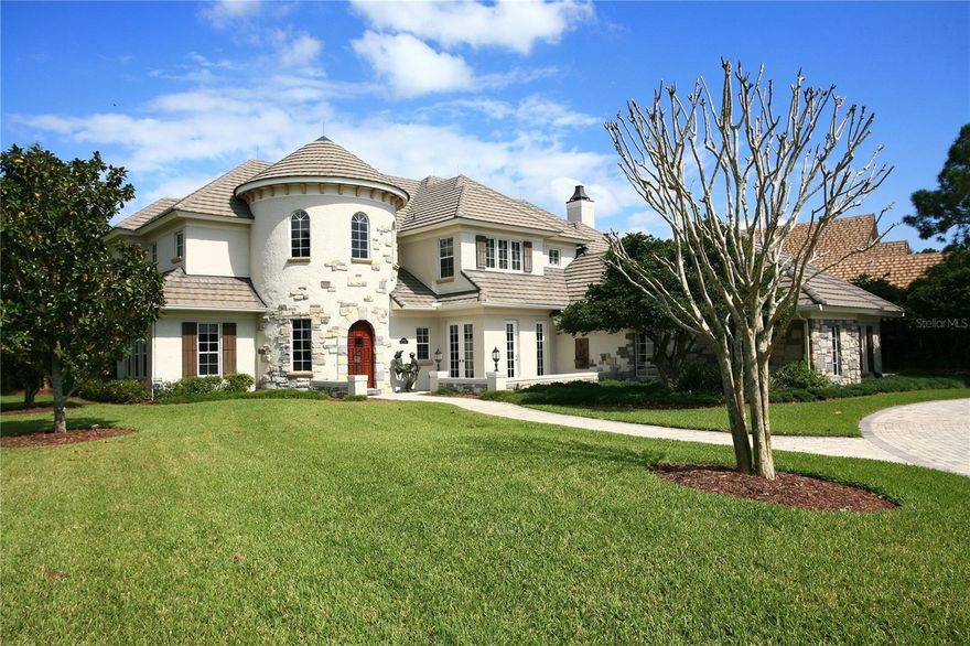 The stunning exterior façade of this exquisite French country home commands your attention with its two-story tower entry.  Situated on a .66-acre homesite, the magnificent aesthetic appeal is simply breathtaking.

Enter through a custom, carved mahogany door into the grand foyer with a stunning spiral staircase and the eye is immediately drawn up to the Florida cypress tray ceiling with mural.  Open, sun-filled living spaces include a two-story family room with fireplace, dining room with hand-painted Monet mural replica and a wine cellar complete with iron entry and stone flooring.  A spectacular chef’s kitchen with breakfast room overlooks the spacious lanai complete with heated spa and stone waterfall.

Additional features include:
      • Master Suite with separate Lounge
      • 1st and 2nd level Offices
      • Screened lanai with summer kitchen and heated spa
      • Oversized second-level Evening Deck w/ wet bar
      • 3-Car Garage with Golf Cart Storage