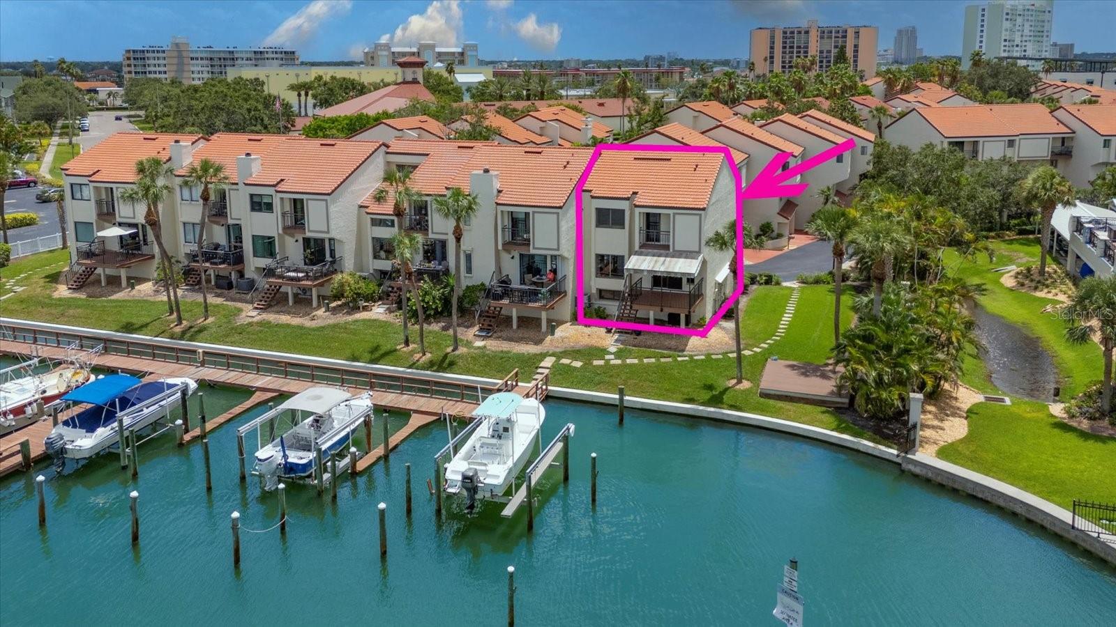 Stunningly renovated and move-in ready, this Island Estates townhome offers the perfect blend of luxury and coastal living. Surrounded by lush, tropical landscaping and walkable sidewalks, with access to a heated community pool, this 3BR/2.5BA gem boasts gorgeous neutral flooring and an open, light-filled layout. The gleaming white kitchen features a massive waterfall-edge island with loads of storage, a wine fridge, stainless steel appliances, and plenty of counter space to prepare memorable meals, all flowing seamlessly into the great room with wood-accent ceilings and breathtaking Mandalay Harbor and marina views to enjoy from a cozy window seat. Sliders open to a private balcony for enjoying tropical breezes, wildlife, and stairs leading down to the dock area. A gorgeous half bath and spacious laundry room complete the downstairs. Upstairs, the primary suite is a true retreat with its own balcony, beverage fridge, custom closets, wood ceilings, and a spa-like ensuite with double sink vanity and a custom walk-in shower. The additional bedrooms are equally well-appointed and share a stylish hall bath with a tub/shower combo. Extras include a 2-car garage with Tesla charger, water barriers for the garage and front doors, boat slip rental availability, and unbeatable proximity to shopping, dining, and pristine beaches. Don’t wait, this one is impressive!