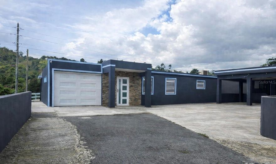 One or more photo(s) has been virtually staged. Exclusive residence nestled in the sought-after Río Abajo area of Cidra, set on an impressive 2,648 square meters of fully fenced land that offers privacy, serenity, and refined living. This elegant property features a spacious master suite with walk-in closet and a private bathroom, an additional bedroom, and is sold with select appliances included for added convenience. The home boasts an electric gate, a covered garage, and an additional garage ideal for multiple vehicles and/or an entertainment space. Designed for elevated outdoor living, the property includes a gazebo area perfectly suited for a resort-style pool and BBQ lounge. The residence is equipped with a solar energy system, enhancing energy efficiency, sustainability, and overall quality of life. Ideally located just minutes from town and key points of interest, and enhanced by Cidra’s year-round cool and refreshing climate, this exceptional property delivers a rare blend of luxury, comfort, and lifestyle.