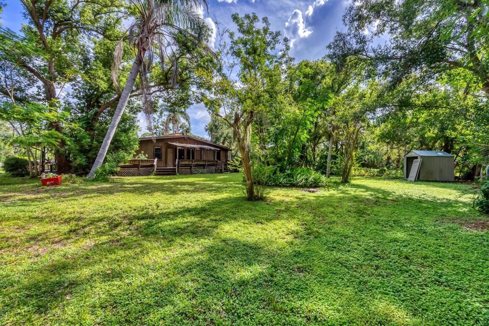 Rare opportunity for multiple family living! Several lots combined to make one, options are endless here. Priced to sell, and opportunities are endless. Conveniently located in the heart of Sarasota, with mature landscaping, walking trail to the park nearby, this is the perfect opportunity to have the space you desire, without the hassle of living on the outskirts of town. The three quarter acre site is comprised of lush vegetation for plenty of shade from the Florida heat. No HOA means complete freedom to park your boat, trailer or RV in the abundant drive space, or build your brand new dream home. Unique and serene are words that only start to describe this one-of-a-kind opportunity. Don’t wait- schedule your private showing today! Sold AS IS.