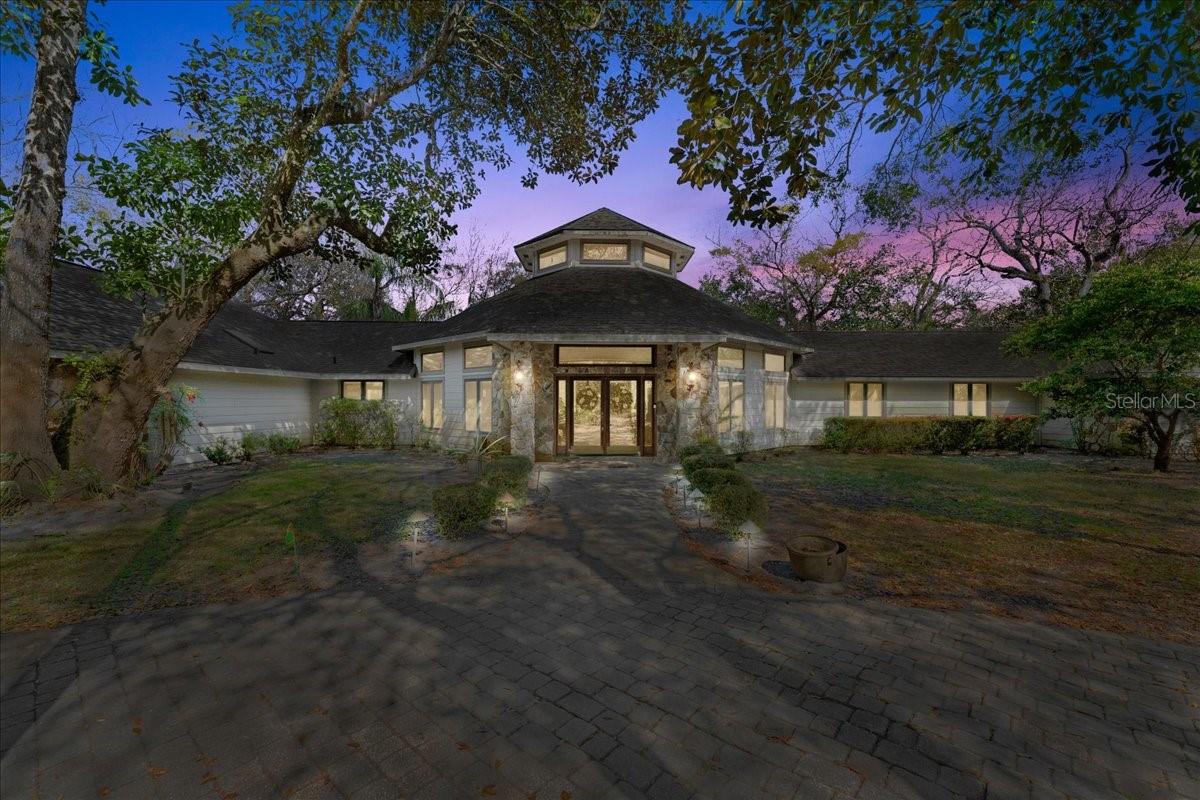 Escape to your private retreat in Flagler Beach! This custom-built, one-owner home sits on 11.5 acres that backs to canal that runs through marsh offering ultimate tranquility and a connection with nature. Located Enjoy the peaceful surroundings from both the front and back patios, or take a dip in the screened-in inground swimming pool. Inside, the grand main living area impresses with soaring 26' ceilings, tongue-and-groove wood floors, and an abundance of natural light from expansive windows. The open floor plan includes a living room with a wood-burning fireplace, a dining area, and a bar area perfect for entertaining. The spacious kitchen features a center island, breakfast nook, and ample cabinet and counter space. The extra-large master suite is a true retreat, boasting two walk-in closets and a private master bath with a stand-up shower and garden tub. Each of the three bedrooms has its own private bathroom, offering ultimate convenience and privacy for family and guests. Additional highlights include an inside laundry room and a 3-car garage. Nestled in a private location, this stunning home offers the perfect blend of nature and comfort, all just minutes from Flagler Beach. Square footage received from tax rolls. All information recorded in the MLS intended to be accurate but cannot be guaranteed.