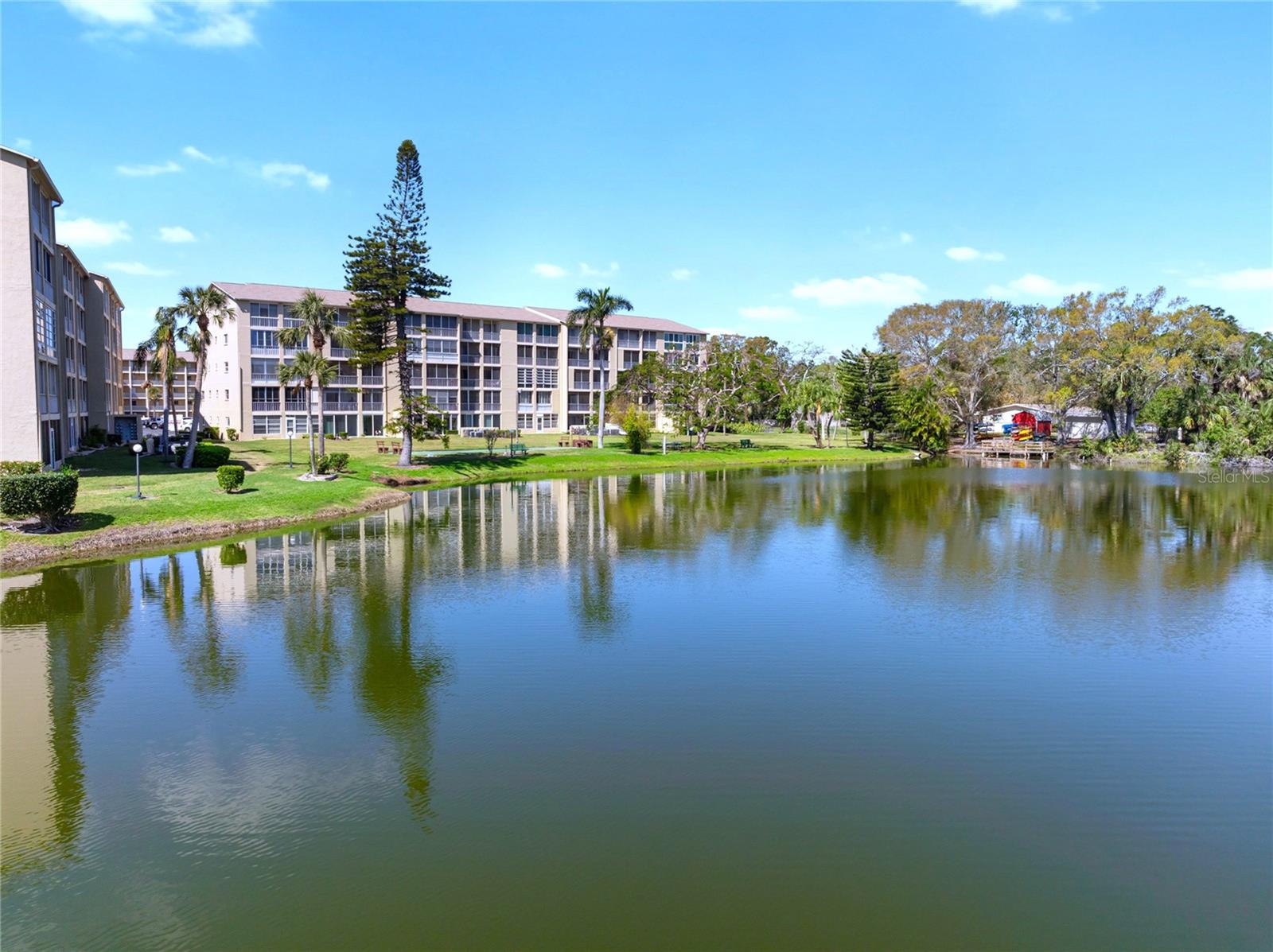 Welcome to your peaceful retreat at Lake Bayshore! This charming 2-bedroom, 2-bathroom CORNER UNIT offers 1,144 square feet of comfortable living, with beautiful LAKE VIEWS from both the living room and primary bedroom. Wake up to stunning sunrises over the lake right from the comfort of your primary suite, creating the perfect start to your day.
Enjoy your morning coffee on the spacious lanai, take in the tranquil water scenery, and even launch a kayak right from your backyard! Inside, the FULLY REMODELED KITCHEN provides a fresh and functional space, while HURRICANE IMPACT-RESISTENT WINDOWS add peace of mind. The living room is extended, offering extra space that can be used as a cozy reading nook, a TV area, or even a bar for entertaining. The guest bedroom is bright and welcoming, perfect for visitors or a peaceful retreat, and the second bathroom offers added convenience for guests.
As part of a friendly 55+ community, you’ll have access to a heated pool, clubhouse, shuffleboard courts, and a lakeside pier with benches—the perfect spot to unwind. There’s even kayak storage and three community barbecues for social gatherings. Plus, you're just minutes from shopping, dining, and everyday conveniences.
Located 3 miles from Downtown Bradenton, 7 miles from Bradenton Beach, and 10 miles from Anna Maria Island, this home offers easy access to some of Florida’s best coastal spots. With a newer roof and fresh exterior paint—at no extra cost to you—and no flood insurance required, you can enjoy truly stress-free living.
This is your chance to own an affordable slice of paradise—schedule your showing today! We invite you to check out our property video and the 3D VIRTUAL TOUR, which allows you to “walk through the condo” from the comfort of your couch.
