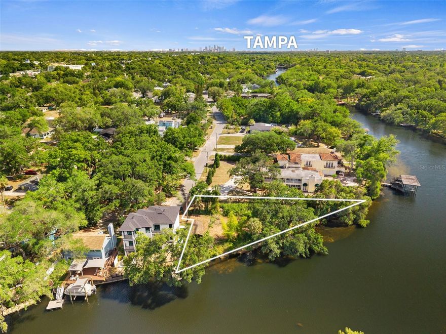 Rare opportunity to own one of the last buildable residential riverfront lots in rapidly appreciating Seminole Heights. This corner parcel delivers breathtaking panoramic river views, direct Gulf access and easy boating to Downtown Tampa, Armature Works and the Riverwalk. Mostly cleared and ready for construction, riprap seawall, the property includes a barn with a slab foundation. Located between million-dollar homes in an up-and-coming neighborhood, this site is ideal for a custom waterfront home or investment. Ask listing agent for survey and potential build options. Don’t miss this exceptional value!