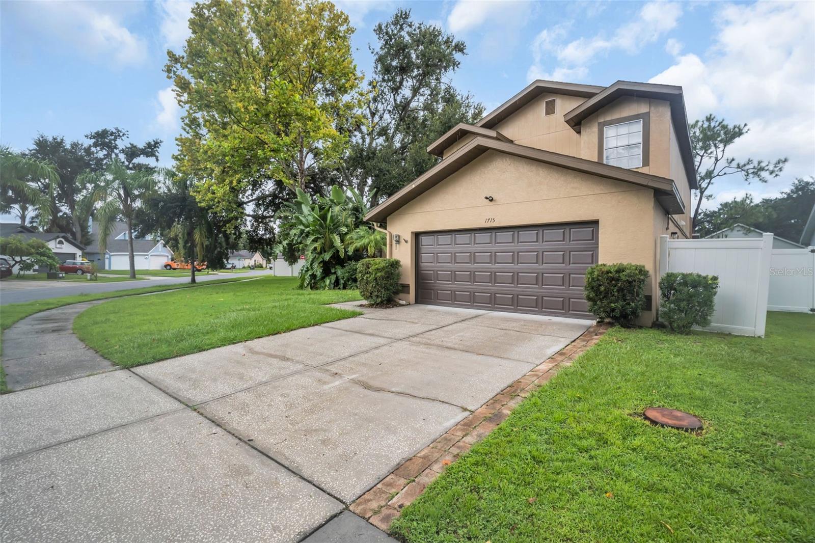 Welcome to this spacious and solidly constructed pool home nestled on an oversized corner lot in a peaceful cul-de-sac setting. Built in 1991,this 3-bedroom + loft, 2.5-bath residence offers over 2,000 sq ft of living space, a 2-car garage, and a host of features ideal for Florida living. Step inside and be greeted by soaring vaulted ceilings—nearly 20 feet high—in the main living area, accented by tile flooring and a cozy wood-burning fireplace that adds warmth and charm. The layout flows seamlessly into a formal dining space and continues into a kitchen equipped with abundant cabinetry, a pantry, and a sunny breakfast nook, perfect for casual meals. The primary suite is located on the main floor for added privacy and convenience, plush carpet, generous closet space, and an en suite bath with dual sinks and tub/shower combo. Upstairs, you’ll find two additional bedrooms, a full bath, and a loft area ideal for a home office, playroom, or media space. Enjoy outdoor living year-round from the screened lanai, newly rescreened in 2023, overlooking the sparkling pool and hot tub. The fully vinyl-fenced yard provides privacy and security, while a side gate and concrete pad offer ideal boat storage or extra parking. A hurricane-rated garage door adds peace of mind, and recent updates such as the 2017 roof, 2017 A/C, and full re-pipe in 2007 ensure long-term value. Located in a well-kept community with low HOA fees and no CDD, this home combines functionality, comfort, and lifestyle—all within close proximity to shopping, dining, and top-rated schools.