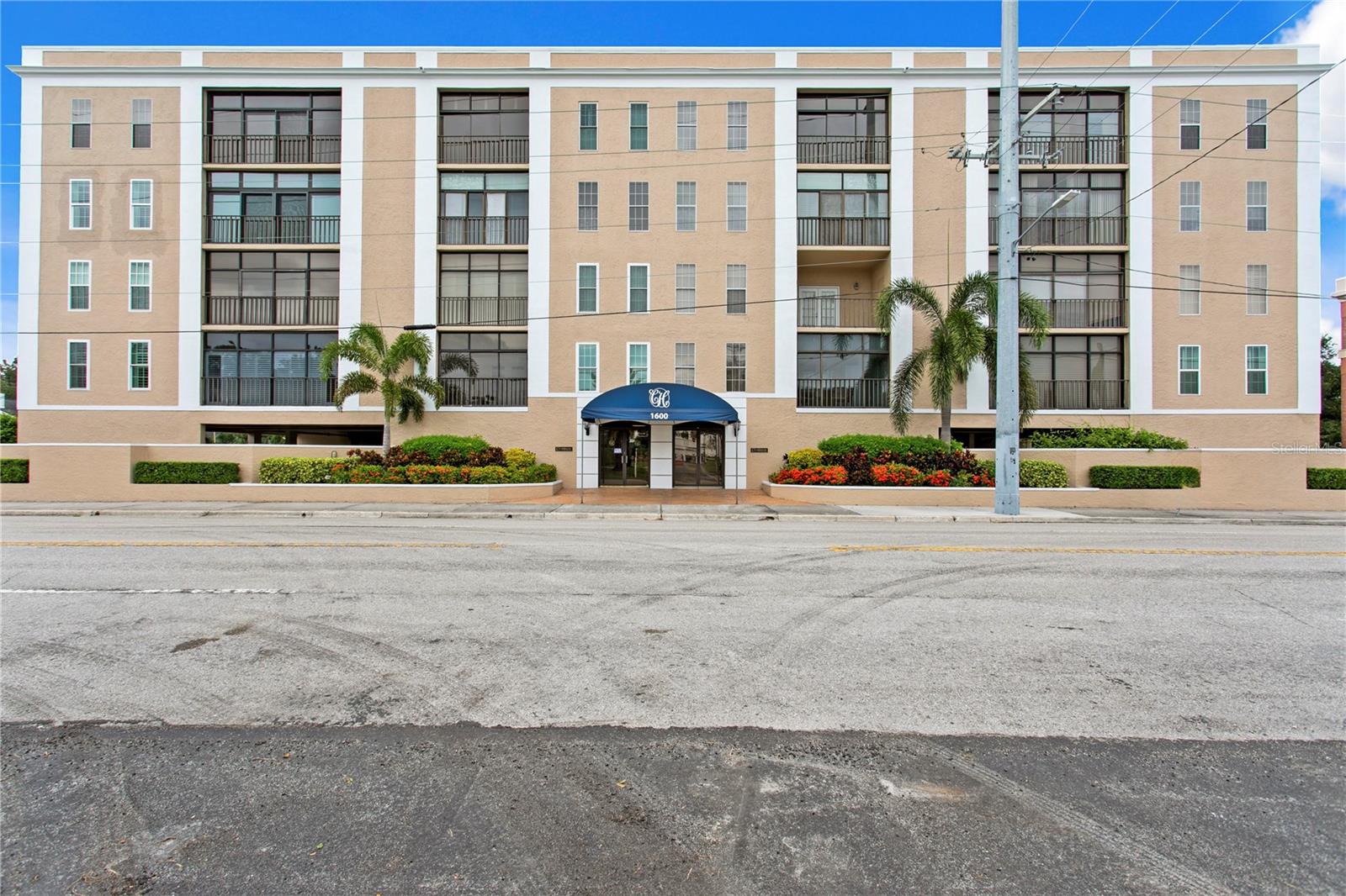 RARE OFFERING at ClubHouse of Palma Ceia! This gorgeous CORNER-UNIT condominium was FULLY REMODELED by John Sample, and the quality shows. Step into your sunny foyer and be greeted by HARDWOOD FLOORS THROUGHOUT and lovely mouldings. Two very spacious guest bedrooms are at the front of the unit, with one bedroom having been converted into use as a lovely den. A spacious kitchen affords plenty of space for most any dinner event, with a beautiful island perfect for serving, and rich wood cabinetry which offers soft-close doors/drawers and granite countertops. Step into the tremendous formal dining room and living room, with tons of room to entertain. The primary suite offers a walk-in closet plus a built-in closet, both with custom closet systems, and a comfortable en suite bath with two vanities, walk-in shower, and water closet. A walk-in laundry room with sink and cabinetry makes your laundry chores a breeze. This unit is WHISPER QUIET thanks to IMPACT RATED WINDOWS AND DOORS with high-end window treatments. FLOOD ZONE X; EVAC ZONE C (the best you can get South of Kennedy). Storage abounds with a spacious storage room off the balcony, plus numerous closets throughout the interior. This complex is gated and features a newly remodeled pool area, two parking spaces in the garage (one reserved and one roaming), and elevator. Walk across to Palma Ceia Golf and Country Club, or to any number of local restaurants. South Tampa is at your fingertips here! This home is pristine and awaits a new owner!