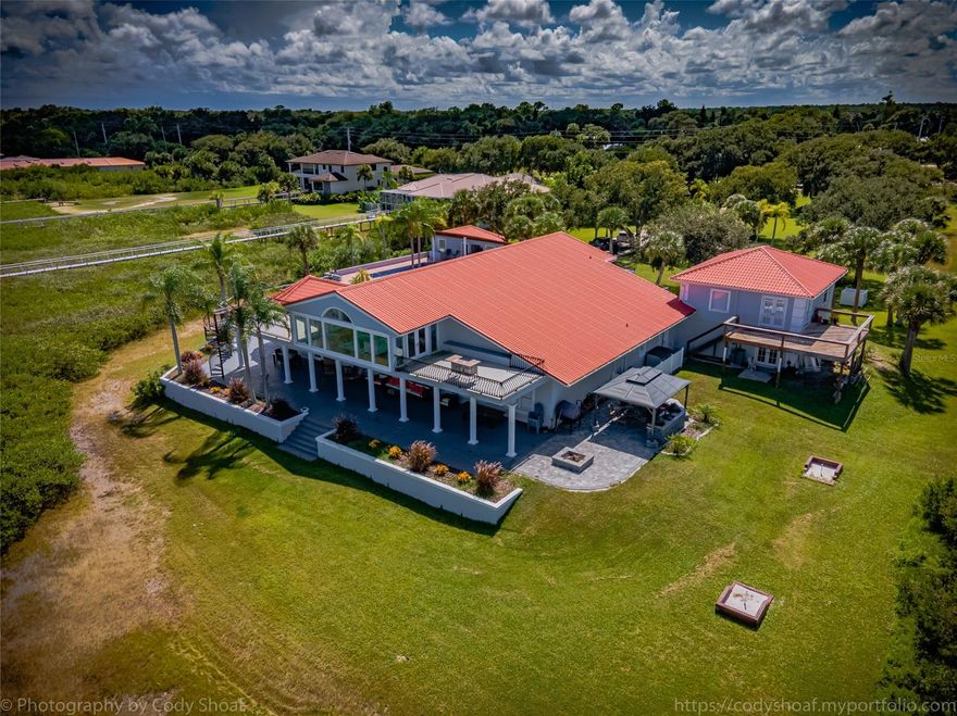 Direct Intracoastal Gated pool home Estate located on a 3 acre parcel that may be subdivided.*** outside oasis features summer kitchen with **Multiple BBQ stations, Santa Maria grill, pizza oven, fire pit, and granite countertops.** Pool cabana offers poolside kitchen with water, electric and an unfinished full bath. There is a one bedroom apartment with full bath above the garage that is on a separate electric meter. The apartment mirrors the look of the home and has new appliances. A deep water dock sits directly on the deep water intracoastal. ***Now the home!! *** which consists of 4 bedrooms: one currently being used as a media center and one as a game room with pool table, shuffle board, darts and bar.
Each of these two rooms have full baths adjacent to them. master en suite located on the main level*** boasts fireplaces along with two walk in closets leading to the master bath. there is also a fireplace above the free standing soaking tub, separate shower and dual granite top vanities.
kitchen offers wolf gourmet stove and convection oven***, free standing ice maker***, 2 refrigerators, and a blend of granite, quartz and glass tiles. There is also a half bath located off the foyer.***a wine room*** Bar/Library*** is a work in progress*** an ** observation room ***overlooks the vista to watch the sun rise and for star gazing. The flooring throughout is all hard wood. The interior and exterior have been painted recently. ;Water: City