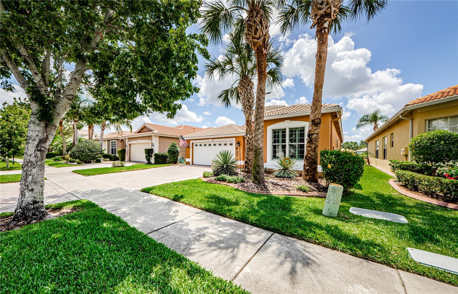 Welcome to 4947 Sandy Brook Circle - an elegant and exceptional Genova floorplan built by GL Homes in 2008 in the highly desirable Valencia Lakes 55+ resort-style community. This stunning 2 bedroom, 2 bath home with a dedicated office will capture your eye from the moment you arrive, you'll be impressed by the beautiful curb appeal, welcoming foyer where you will see the true reflection of diligent care and attention this home has received over the years. Inside, enjoy a thoughtfully designed open floor plan with upgraded finishes, including crown molding and tray ceilings throughout. The spacious living areas are filled with natural light, creating a warm and inviting atmosphere that is perfect for both everyday living and entertaining. The kitchen blends nicely with the formal dining and great room to ensure a welcoming floorplan. With plenty of counter, cabinet and pantry space the kitchen is definitely a chef favorite! The primary bedroom is serene with a lovely view overlooking the lanai and sparkling pond. The primary bathroom has his and hers vanities, garden tub, zero entry shower and walk in closet. Step outside to your lavish, oversized screened in lanai, where tranquil water views provide the ideal backdrop for morning coffee or sunset dinners. This home has been maintained to top-notch specifications by a diligent and detailed homeowner, offering a true move in ready peace of mind. Valencia Lakes is renowned for its active lifestyle and resort amenities - including a clubhouse, pools, fitness, tennis, pickleball and countless social activities. Don't miss your opportunity to own this impeccably maintained, waterfront gem in on of Tampa Bay's most sought after 55+ communities!