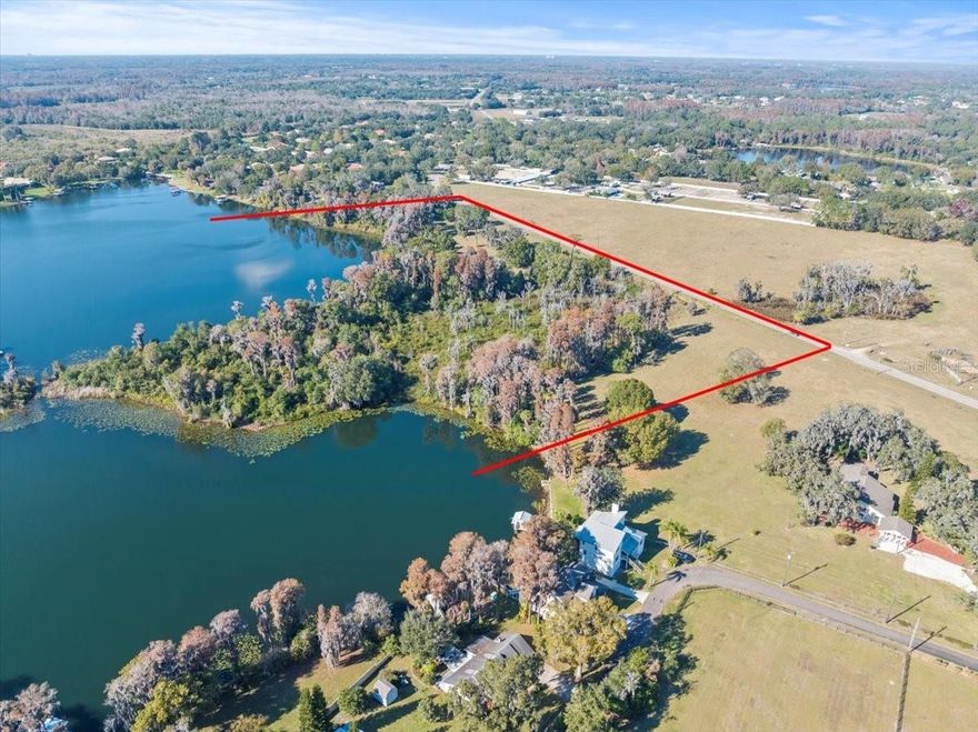 One of Odessa's most beautiful properties with private picturesque setting boasting breath-taking lake views and exceptional lake frontage on two ski sized lakes. This "one-of-a-kind Estate Parcel" has the perfect balance between open pasture for your cattle or horses as well as beautifully wooded areas. This exceptional property is in an excellent area with many beautiful lakefront estates and friendly neighbors within a short walk. Enjoy the quiet country setting just a short drive from shopping and restaurants at the Citrus Park Mall or dinner on the Gulf of Mexico. Must See to appreciate. At owner's request, please do not go onto the property without the listing agent being present.